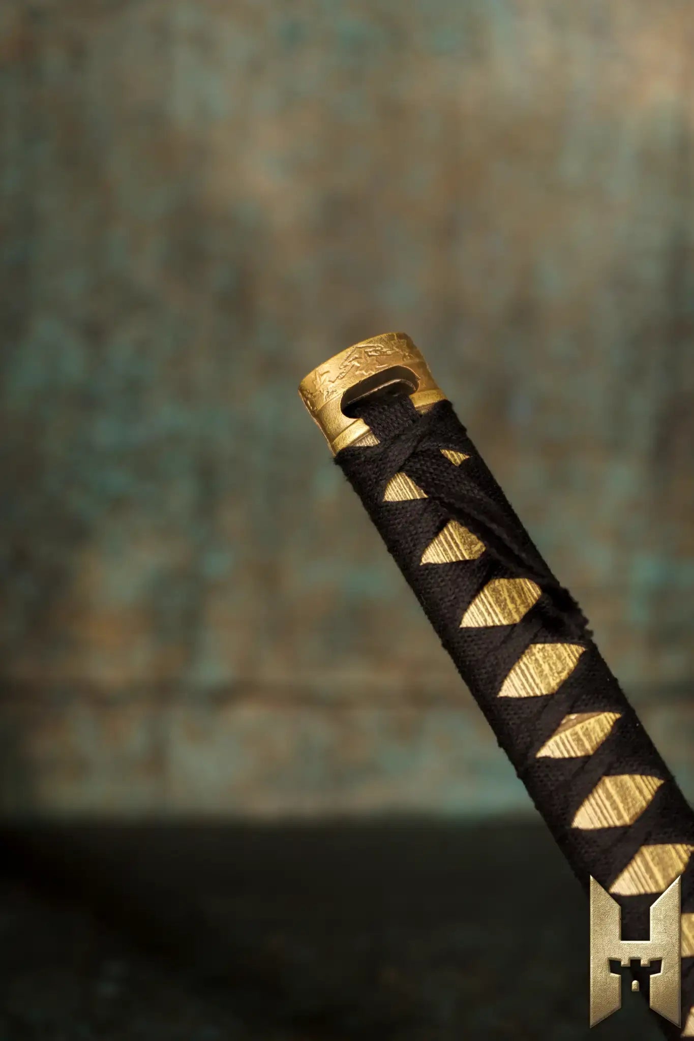Close-up of the handle of Ryūgan the Katana, featuring intricate detailing and a traditional black wrap.
