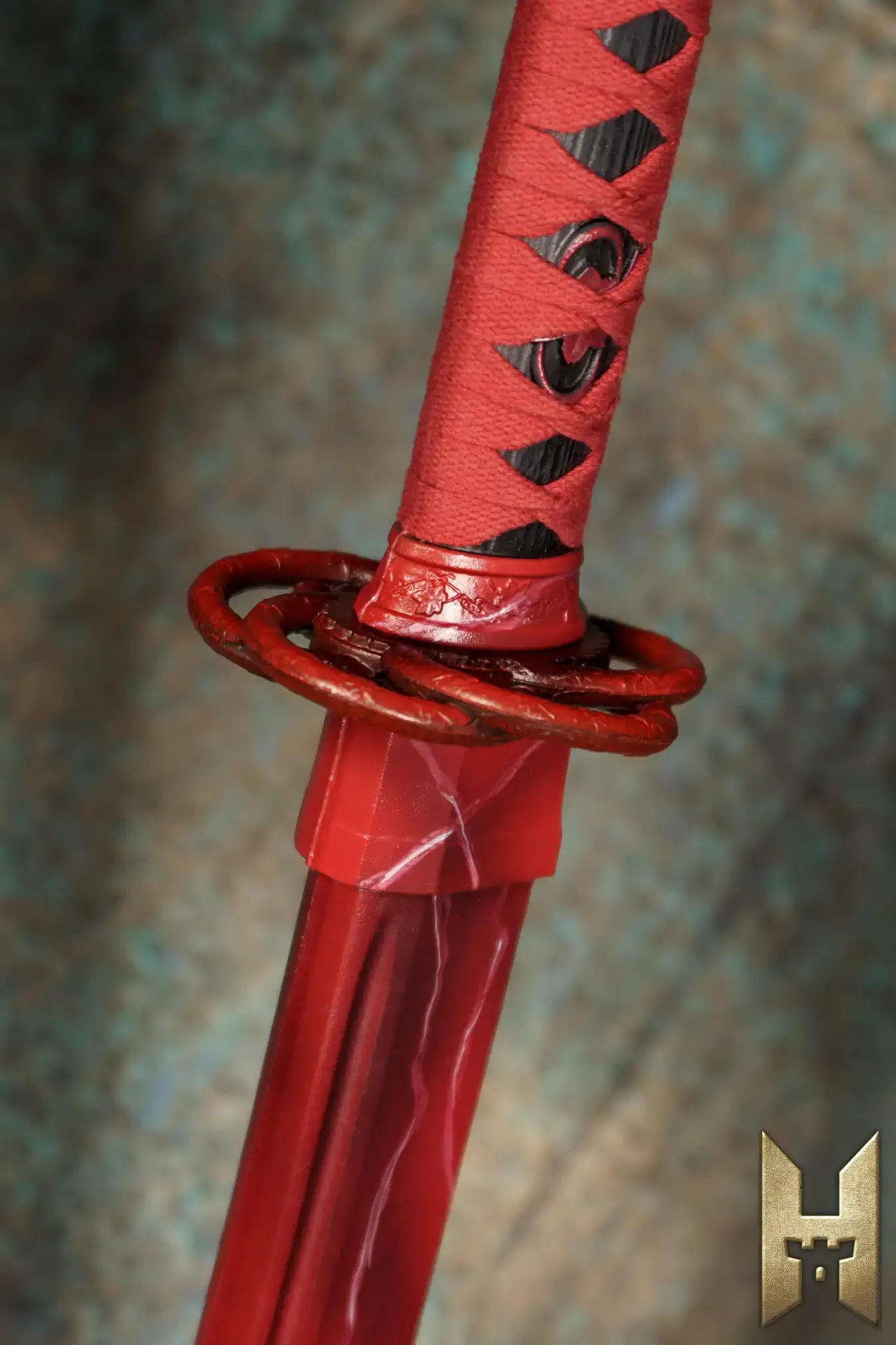 Detailed view of Ryūgan the Katana hilt, showcasing its elegant red handle and intricate design.