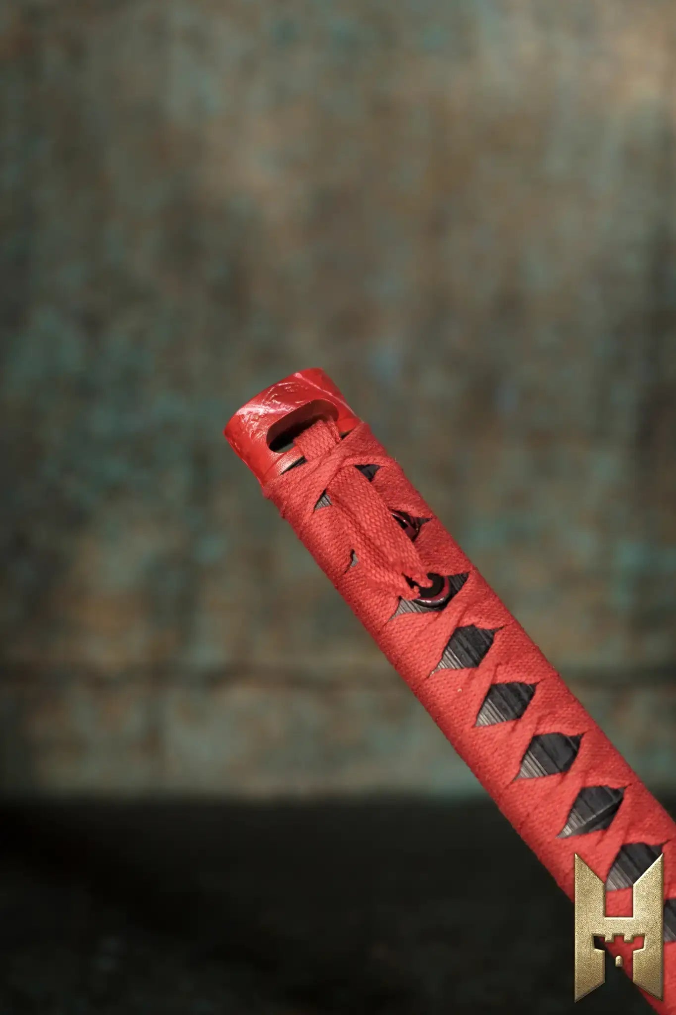 Ryūgan the Katana hilt featuring intricate red and black patterns, showcasing elegance and craftsmanship.