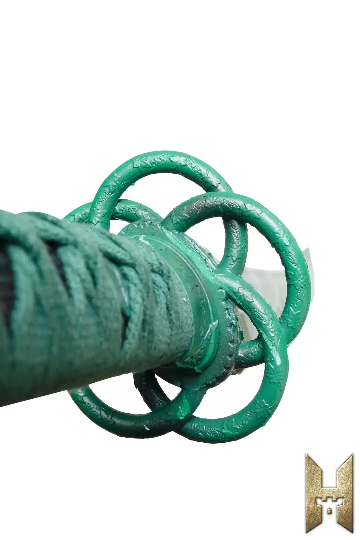 Close-up of the hilt of Ryūgan the Katana, showcasing its unique green design and intricate details.