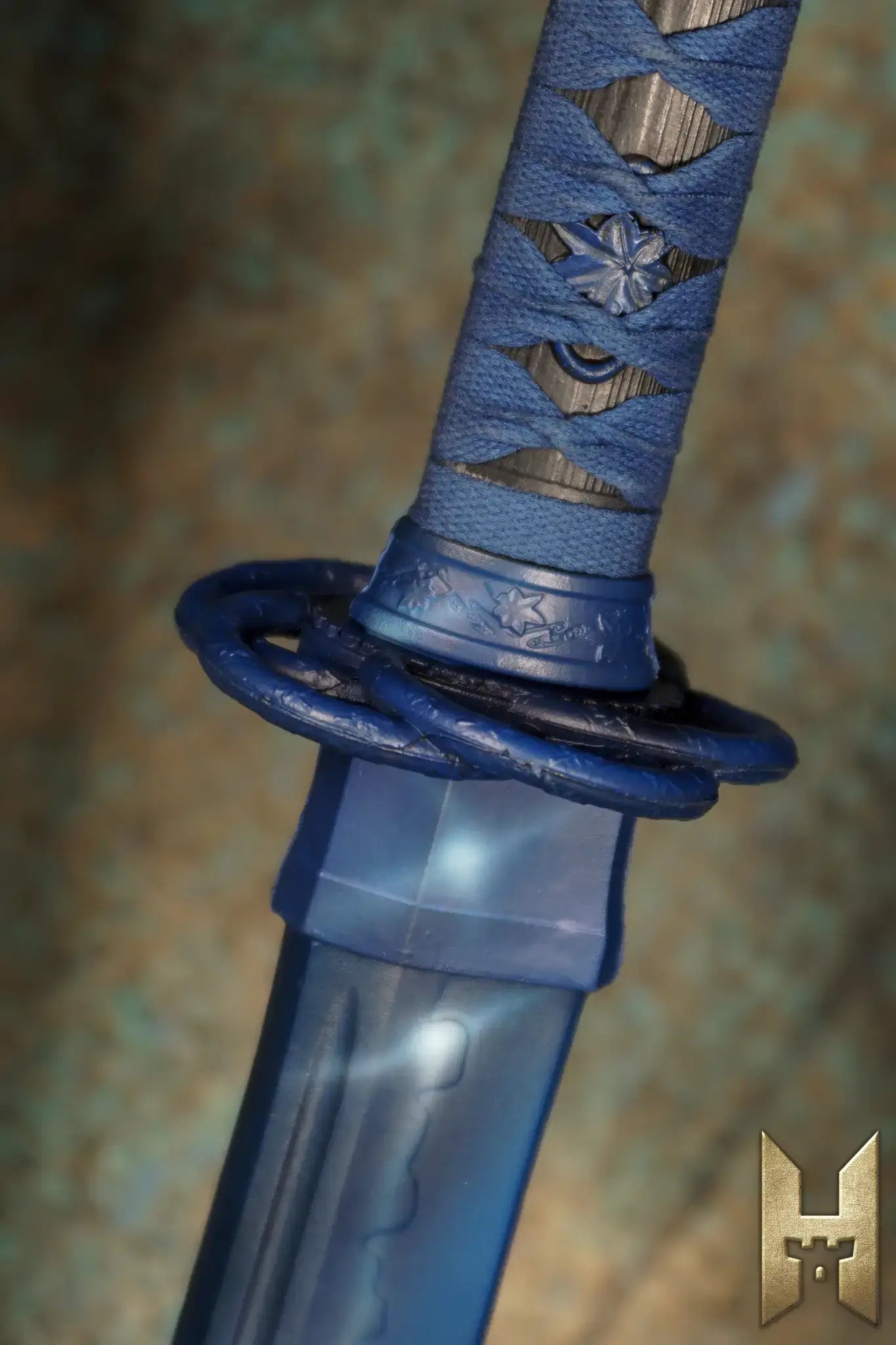 Close-up of Ryūgan the Katana handle with intricate detailing and blue accents.
