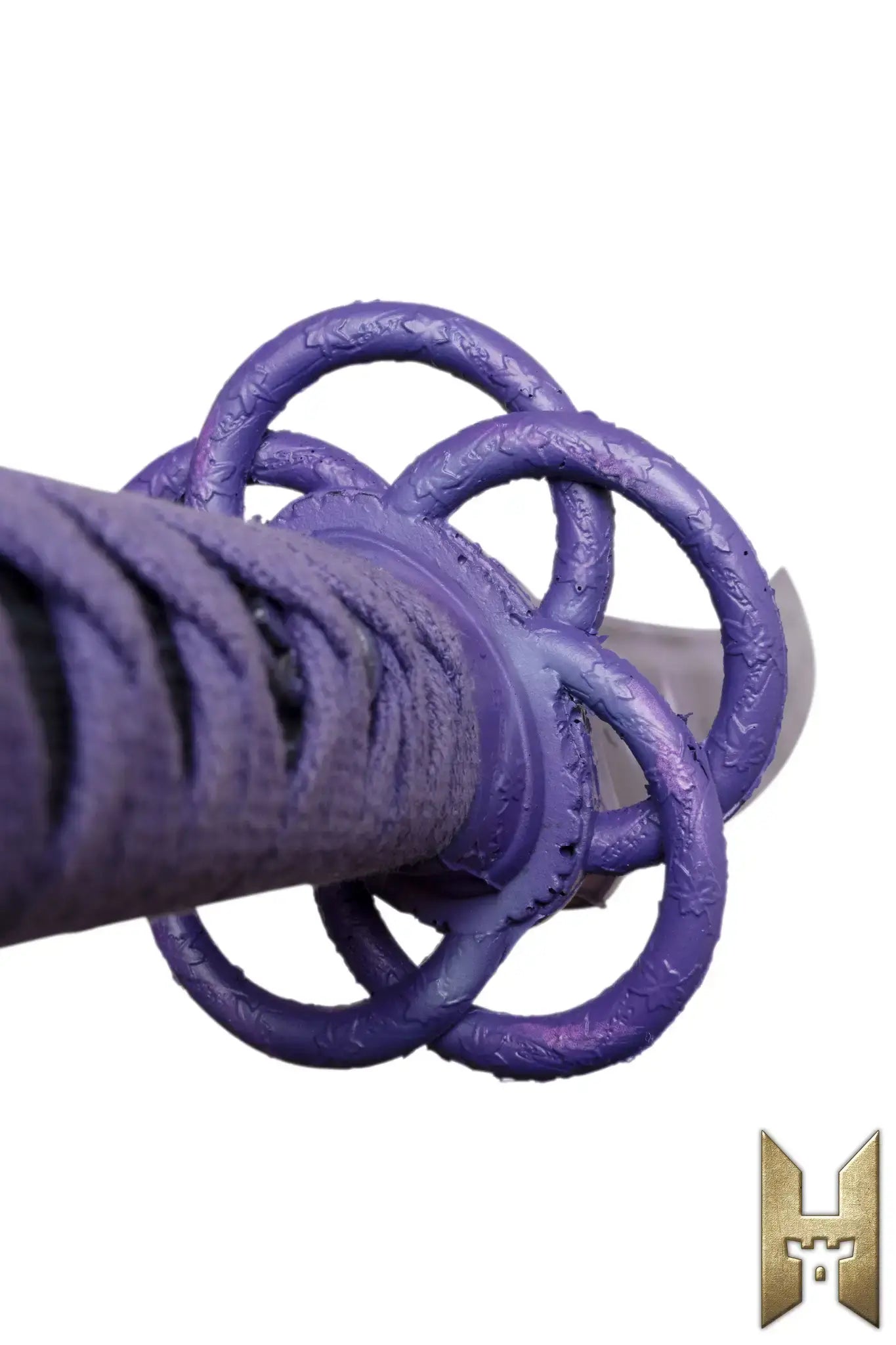 Close-up of Ryūgan the Katana handle featuring decorative rings and intricate design details.