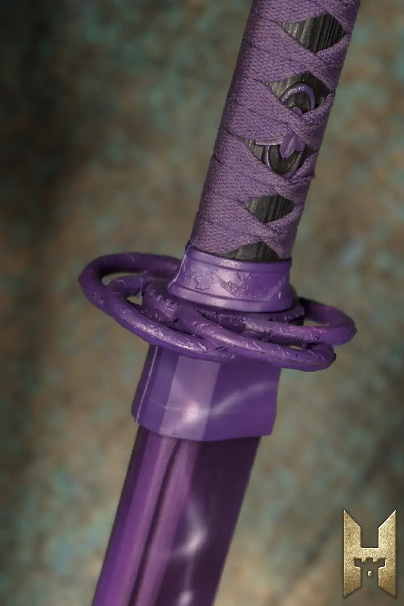 Close-up of Ryūgan the Katana's purple handle and guard, showcasing its elegant design and craftsmanship.