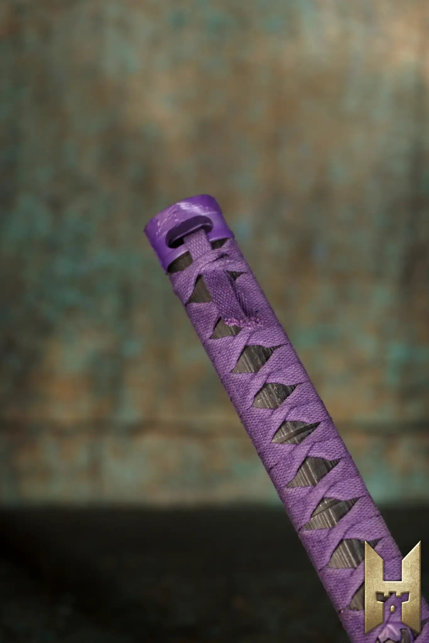 Ryūgan the Katana handle detail with purple wrapping, showcasing its elegance and style from the Stronghold Masters Collection.