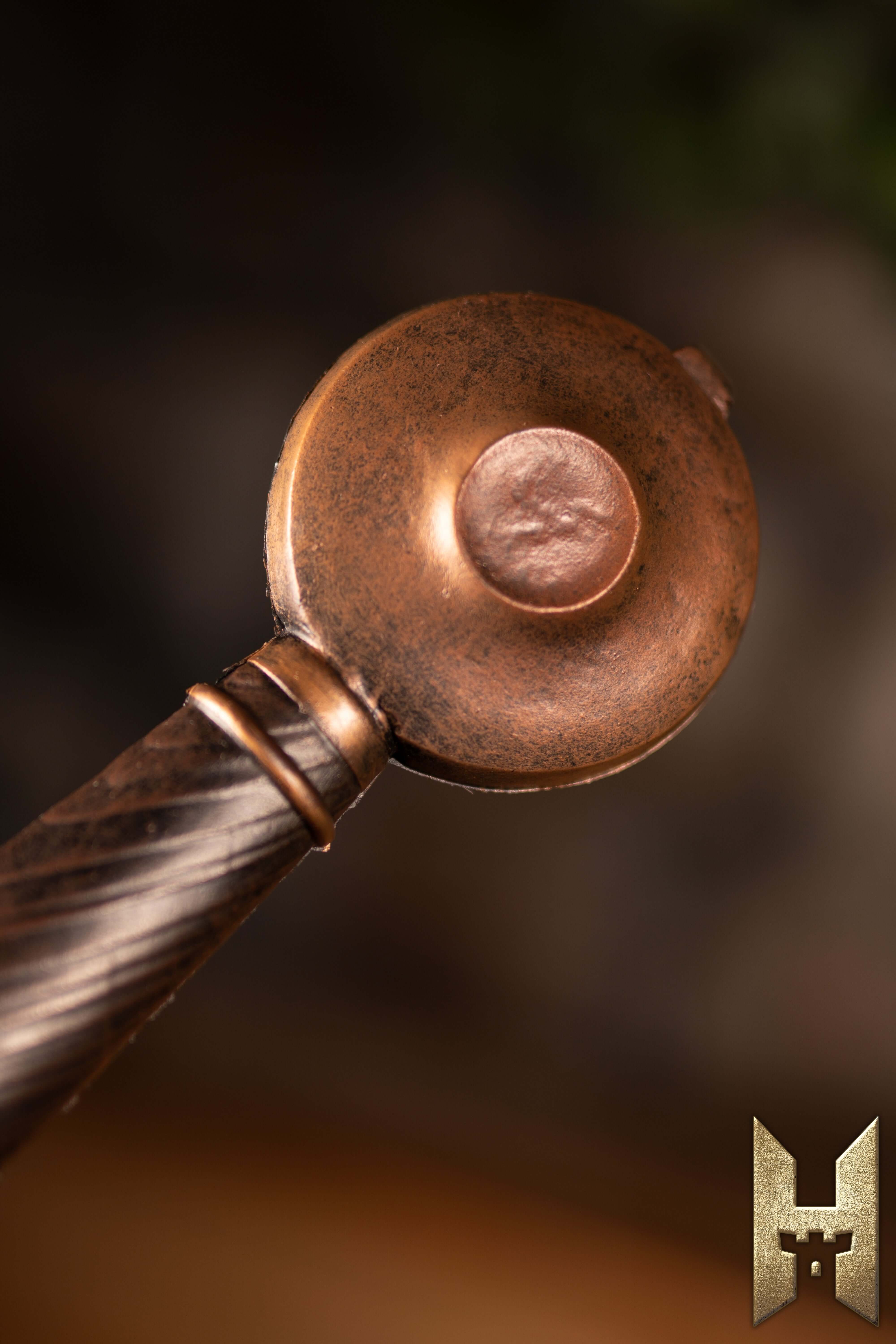 Close-up of the hilt of the Milanese Sword showcasing its intricate design and craftsmanship.