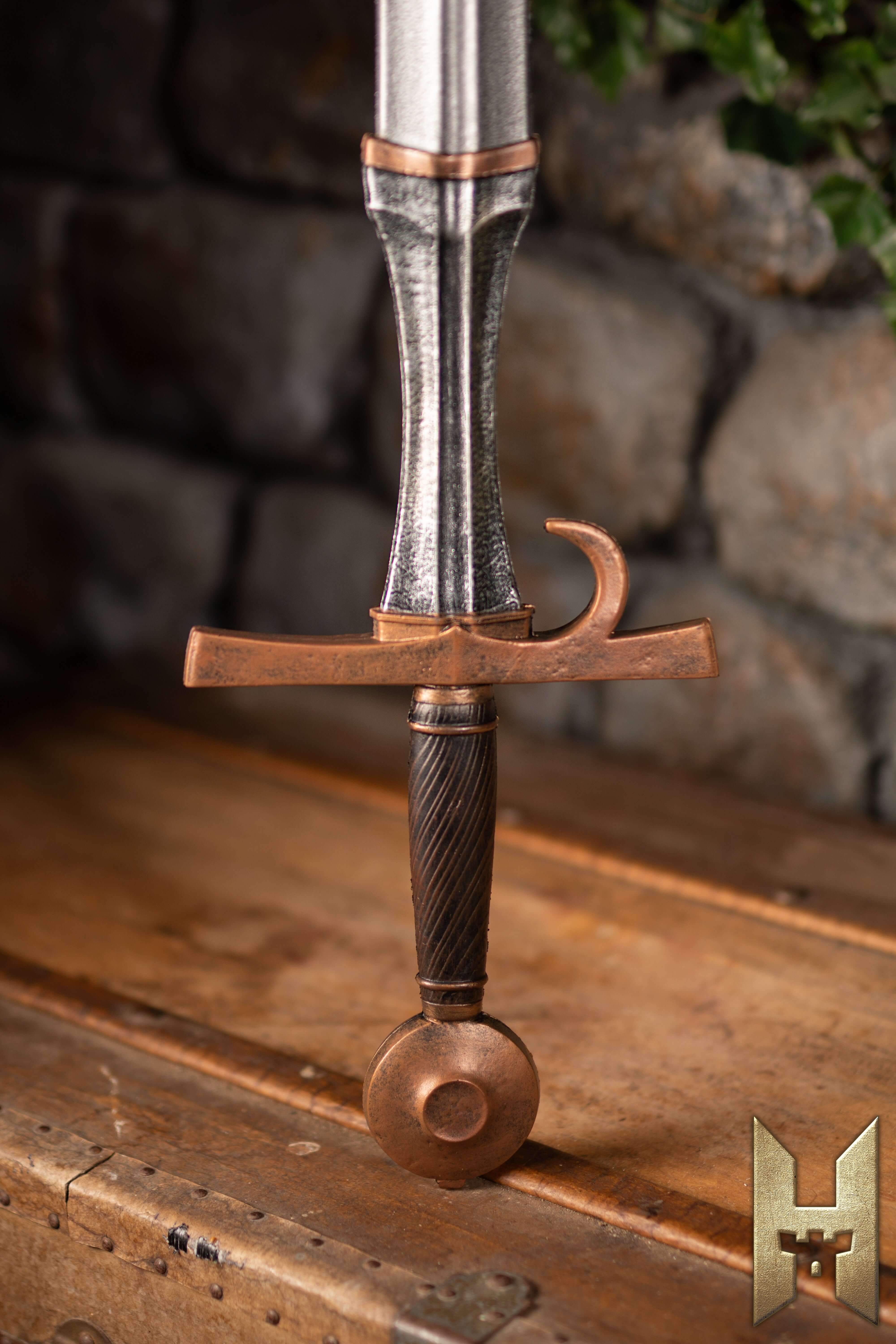 Milanese Sword with a detailed hilt design resting on a wooden table, showcasing Epic Armoury's Stronghold Masters Collection.
