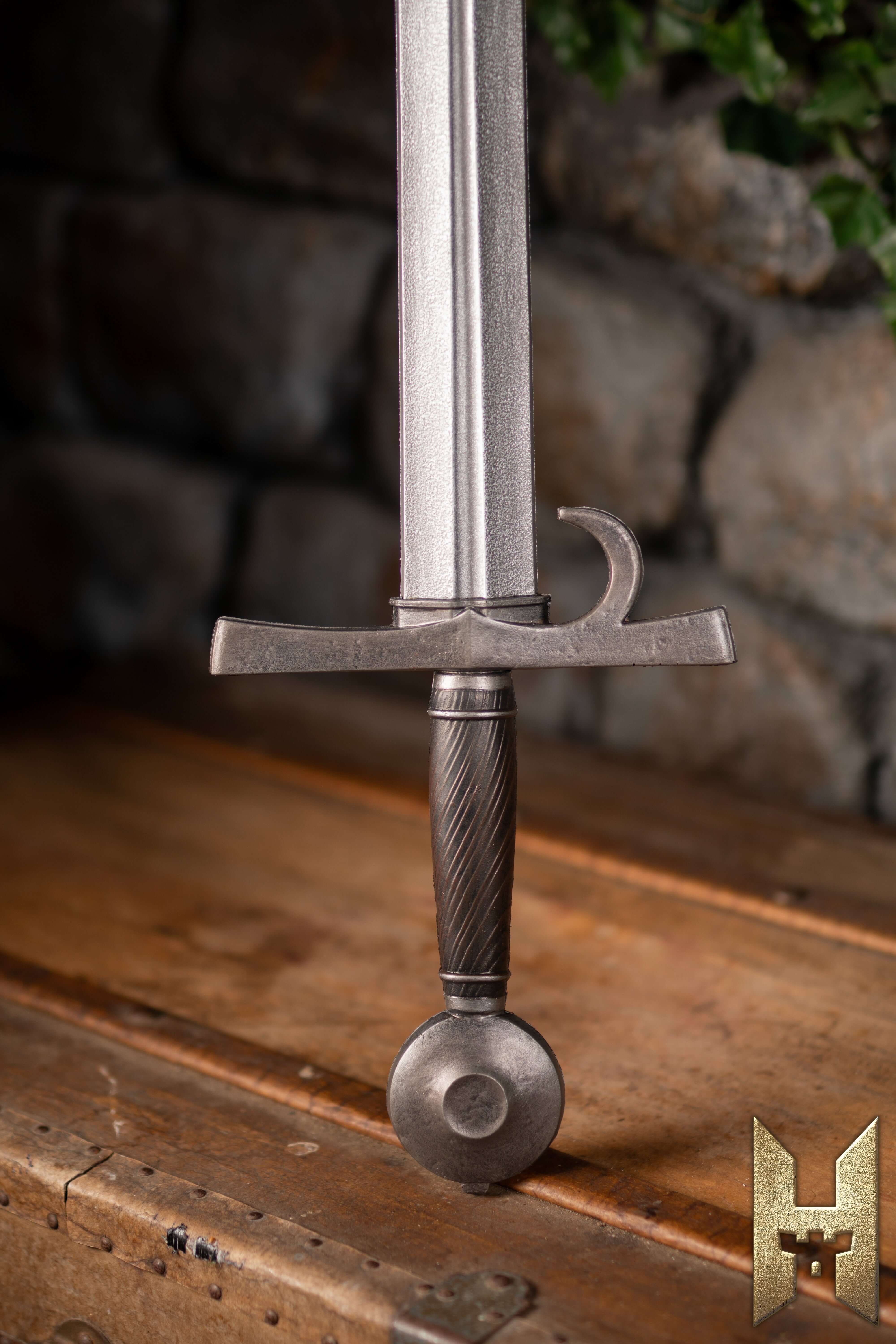 Milanese Sword displayed on a wooden table, showcasing its elegant blade and durable hilt design.