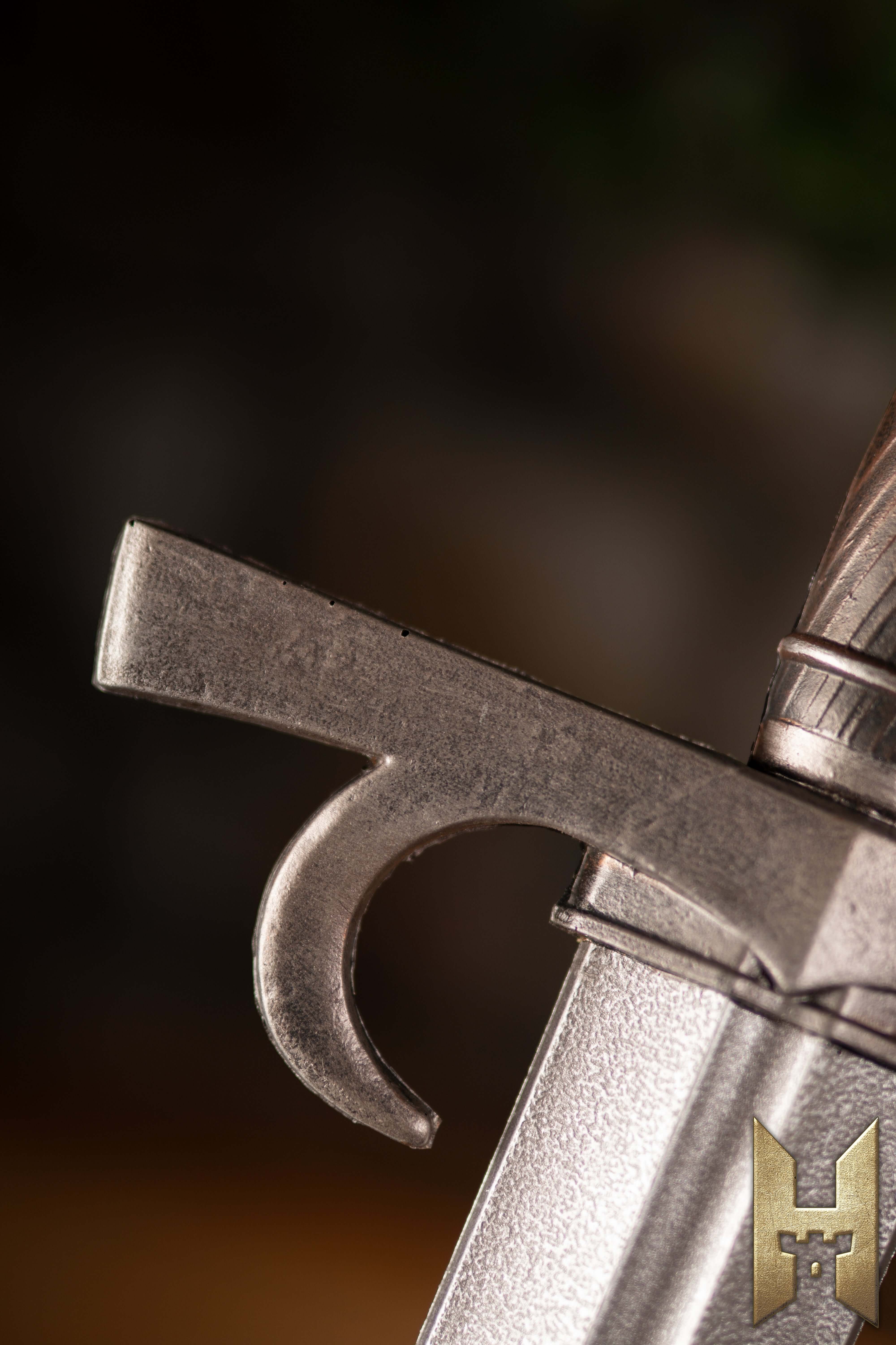 Close-up of the guard of a Milanese Sword, showcasing its detailed design and craftsmanship.