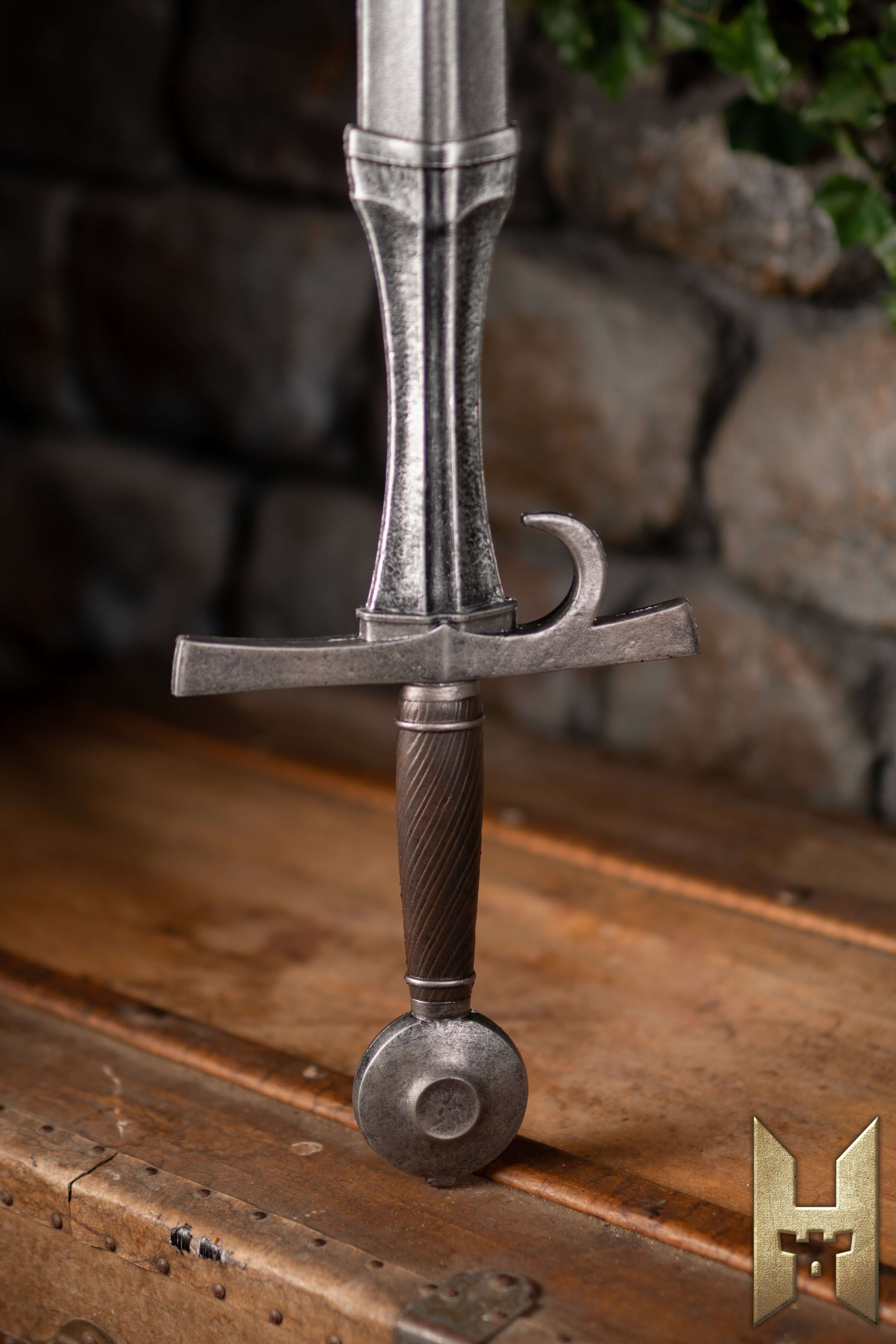 Milanese Sword displayed on a wooden surface, showcasing its elegant hilt and detailed craftsmanship.