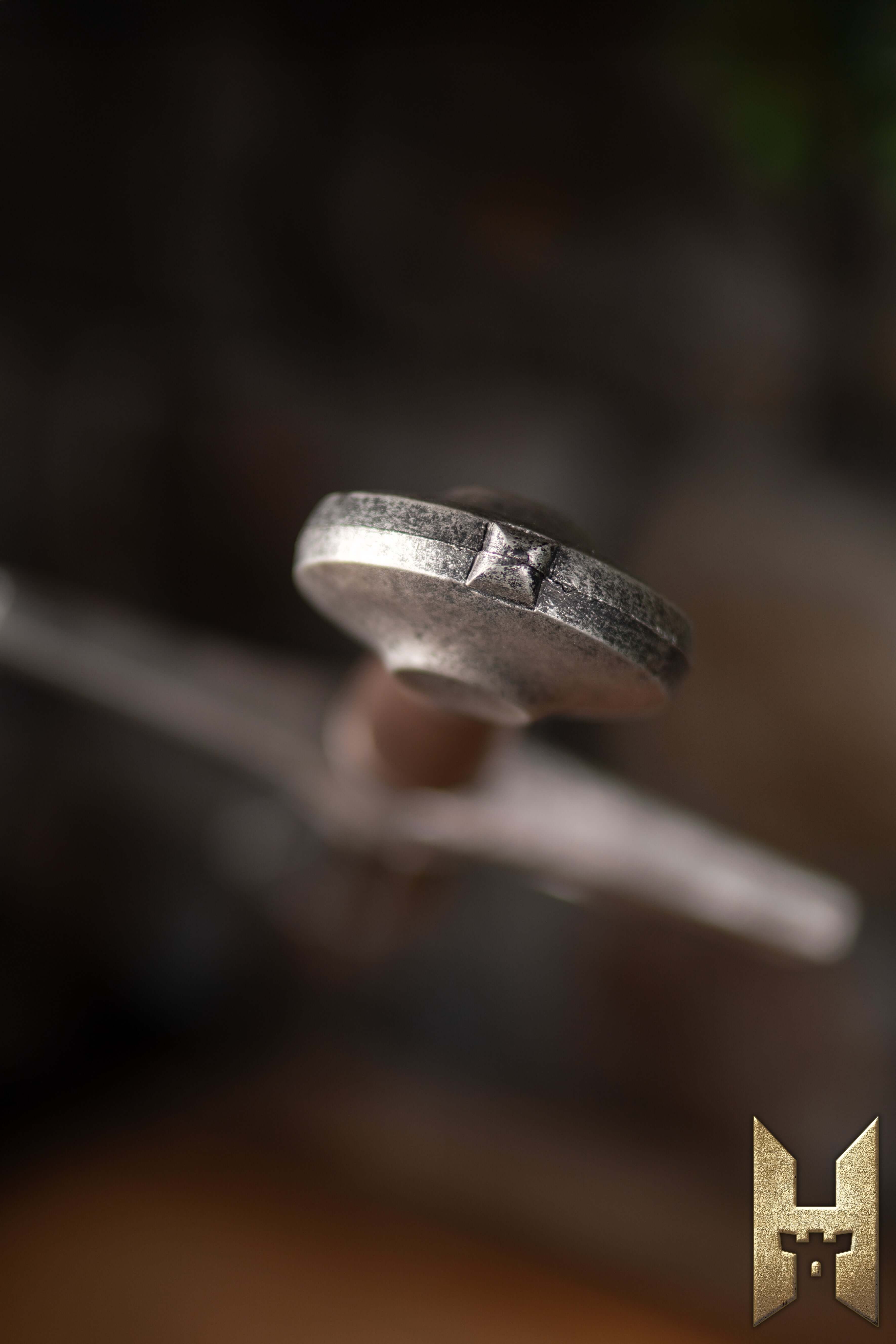 Close-up of the hilt of the Milanese Sword showcasing intricate design and craftsmanship from the Stronghold Masters Series.