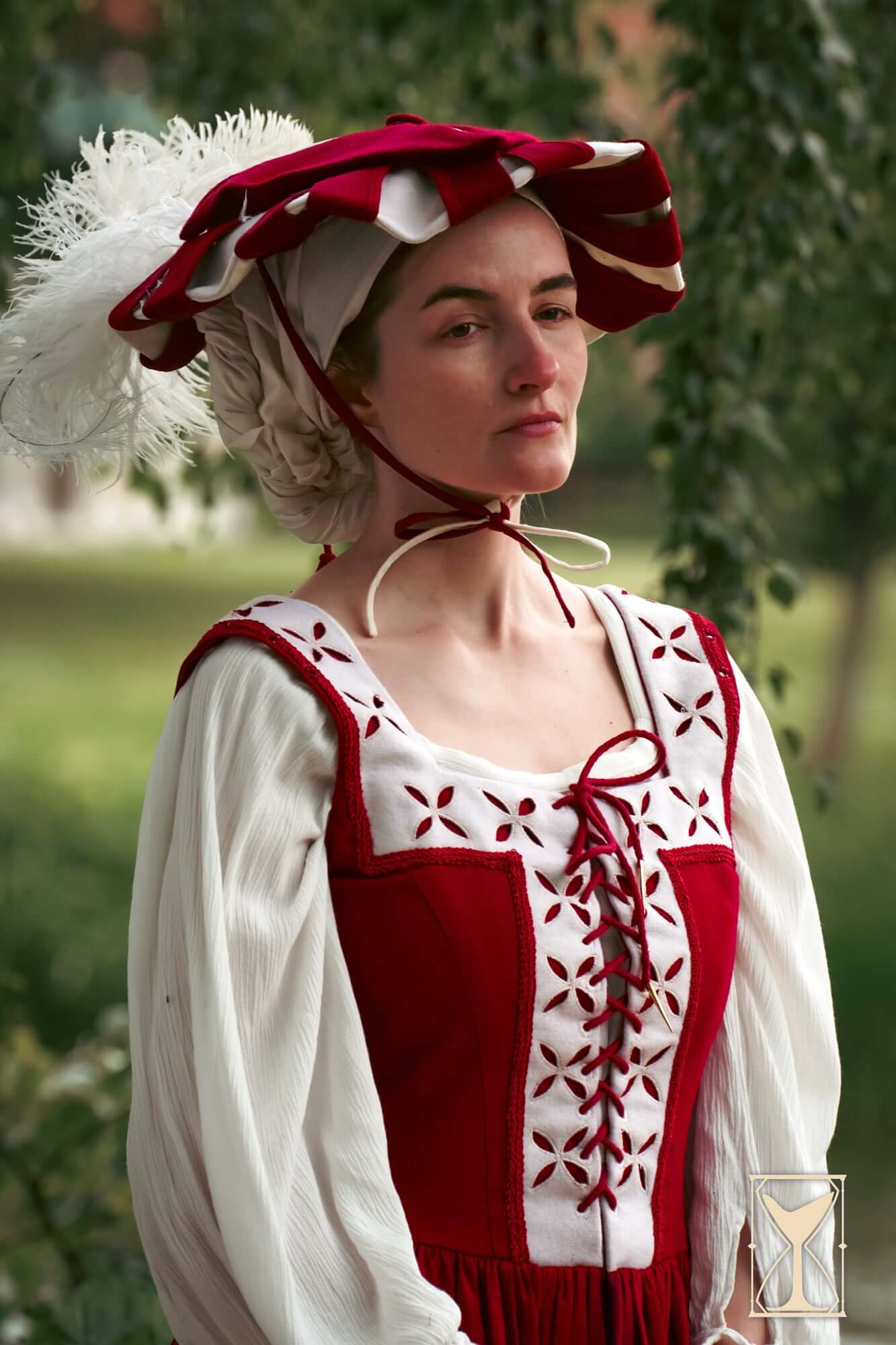 Kampfrau dress model wearing a historical costume with bold colors and unique design in a natural setting.