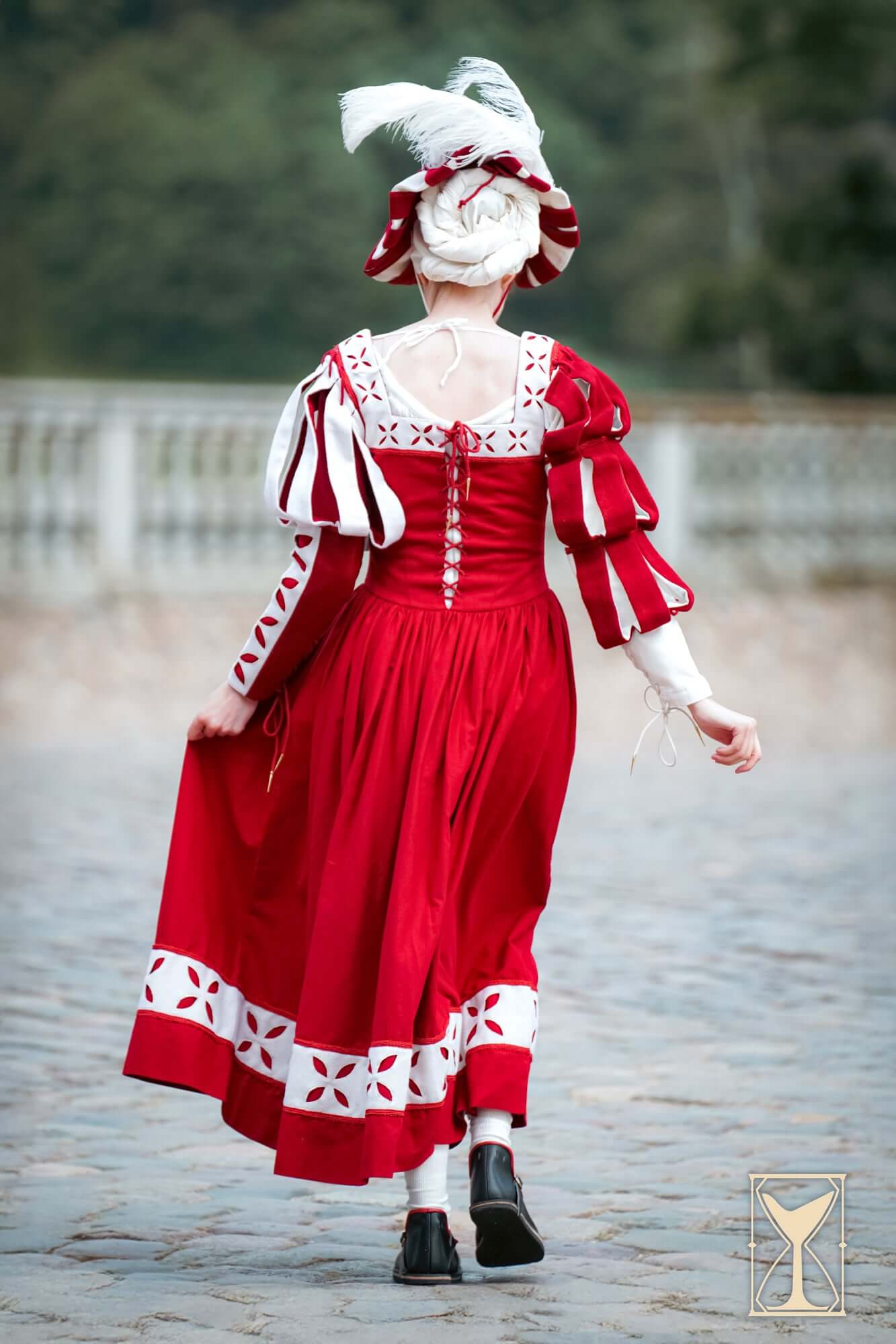 Kampfrau dress in bold red color with historical flair, featuring pleated hem and adjustable design.