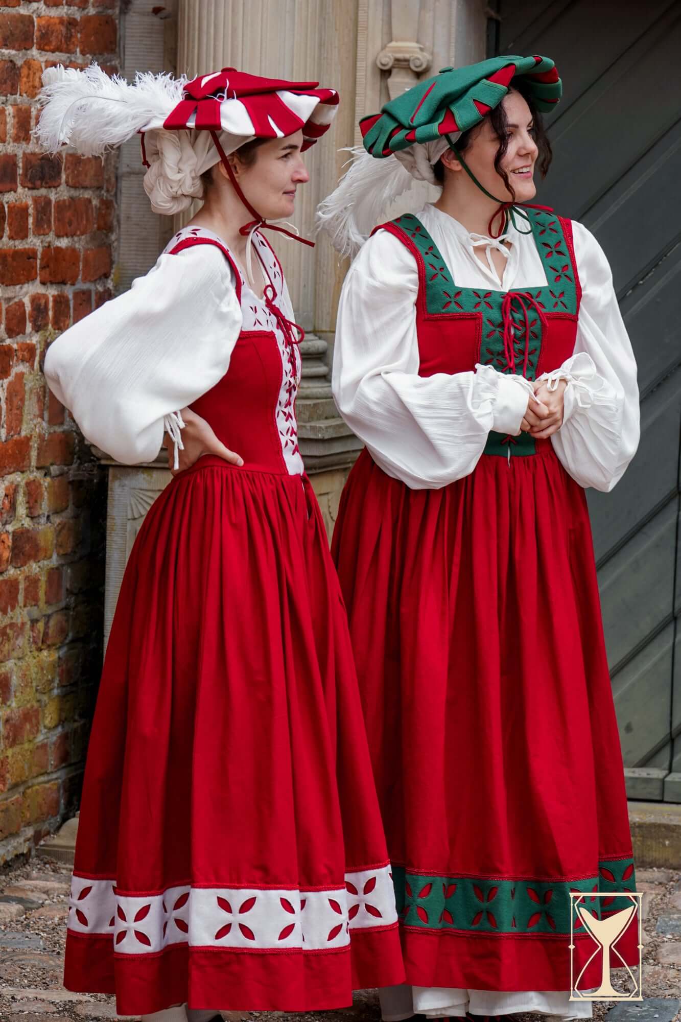 Kampfrau dress displayed by models in red medieval styles with white and green accents.