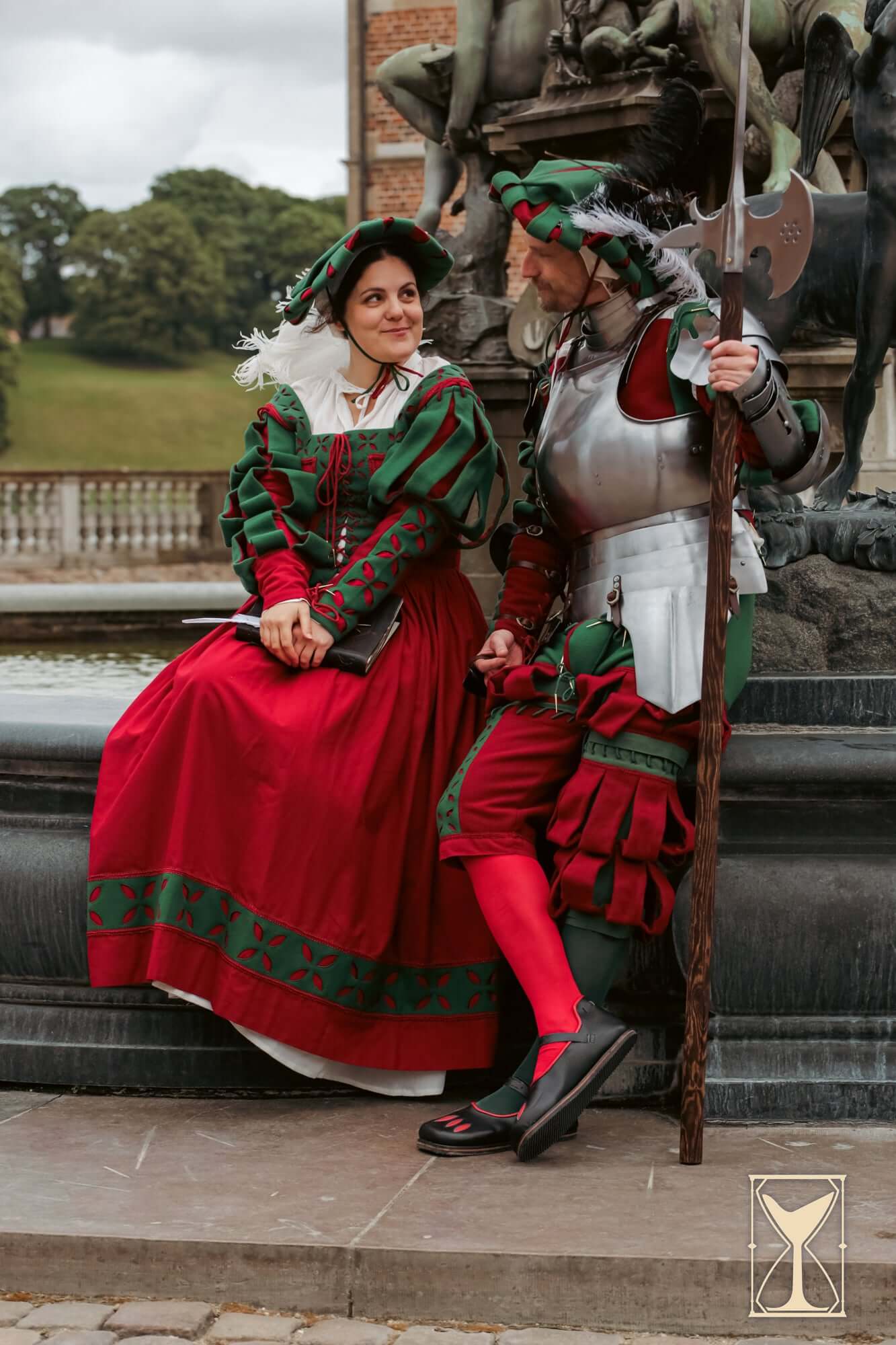Kampfrau dress worn by a woman, featuring bold colors and historical flair, alongside a man in medieval attire.