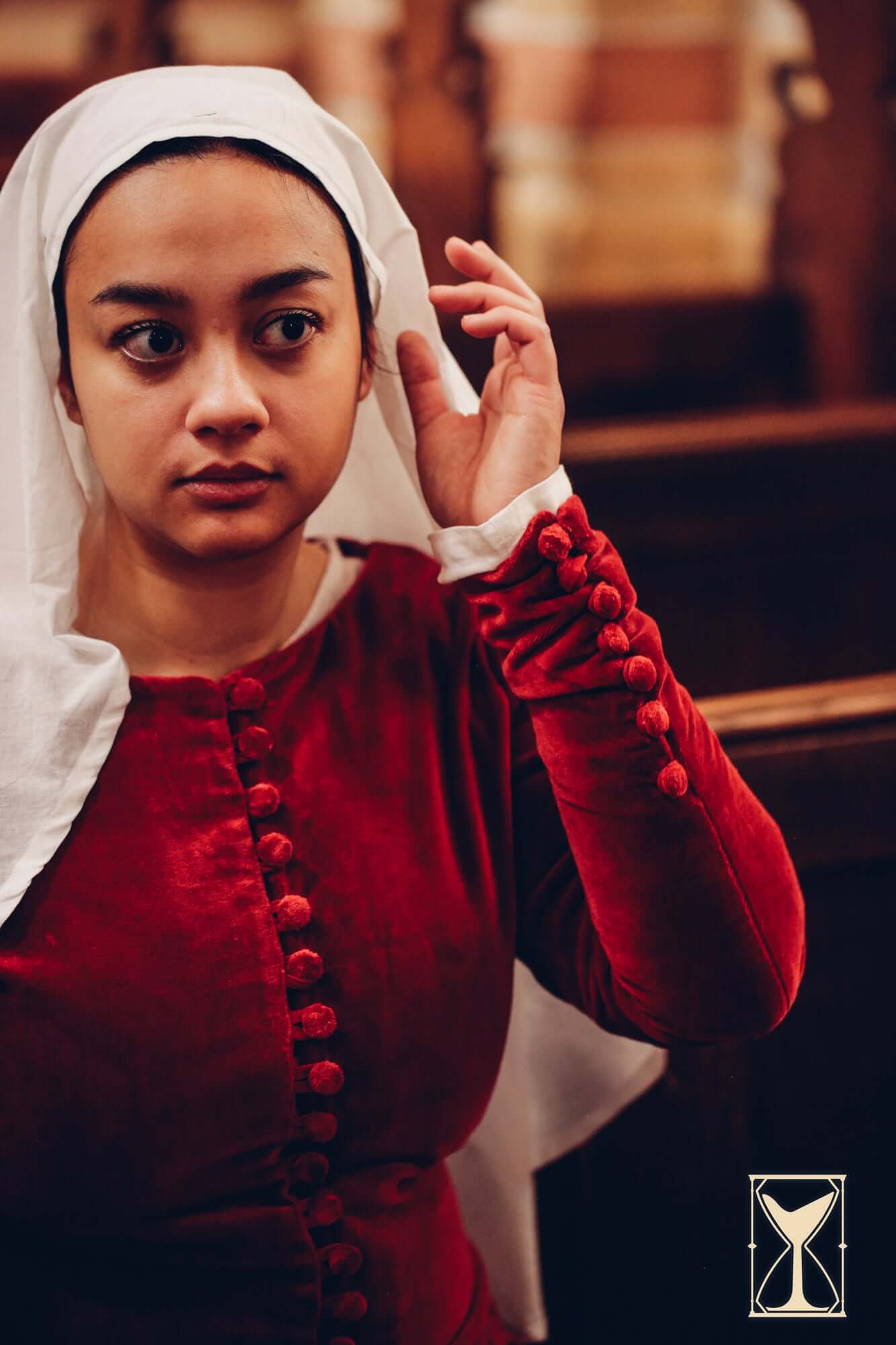 Cotehardie Colette velvet dress with buttons, modeled by a woman in historical setting.