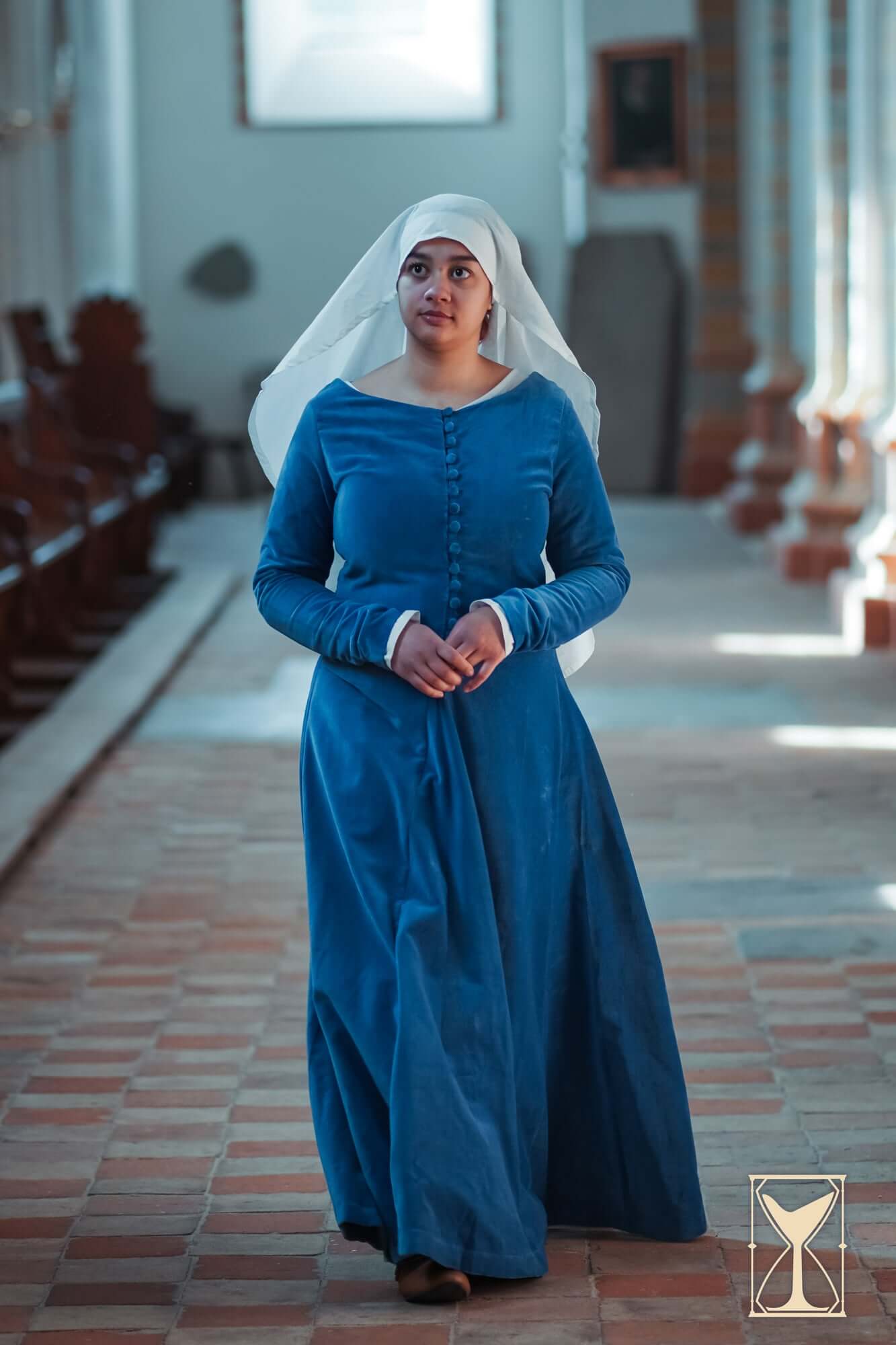 A model wearing the Cotehardie Colette velvet dress, showcasing its fitted design and historical elegance.