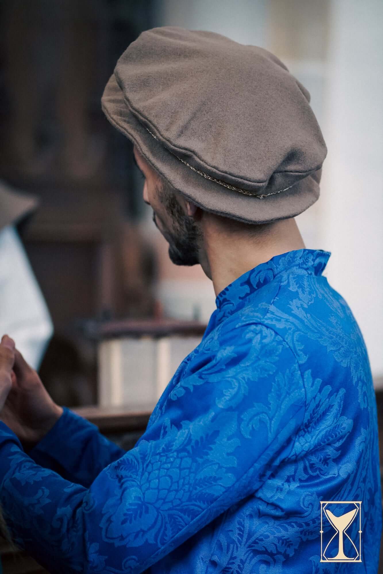 Flat Hat Edward worn by a man in historical attire, showcasing the rounded design and Renaissance style.