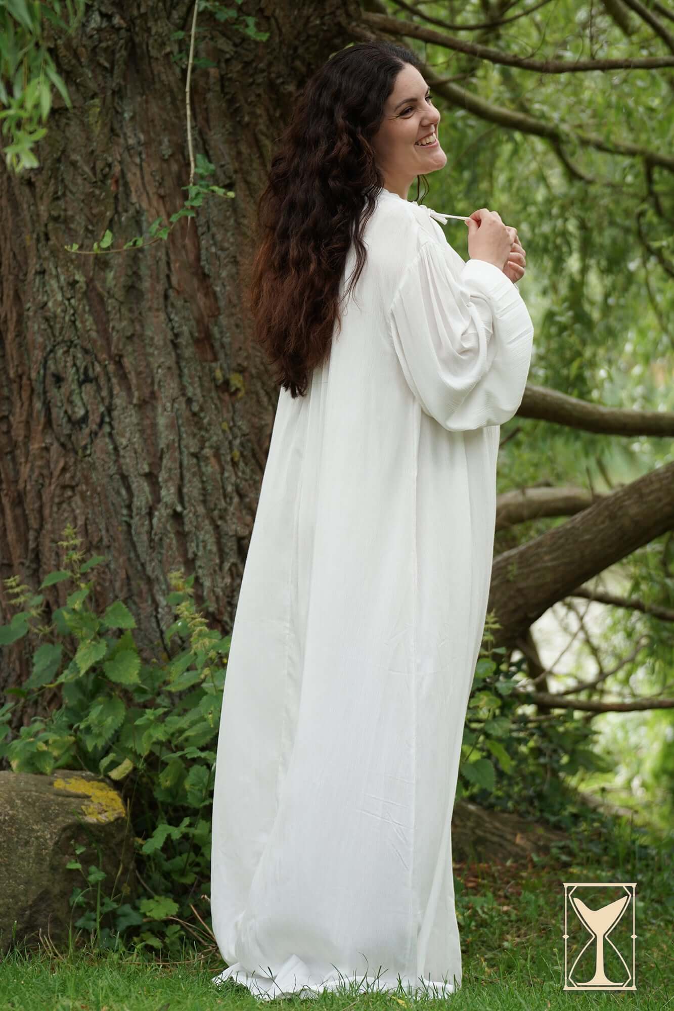 Smock Violet elegant medieval undergarment displayed by a model in a lush outdoor setting.