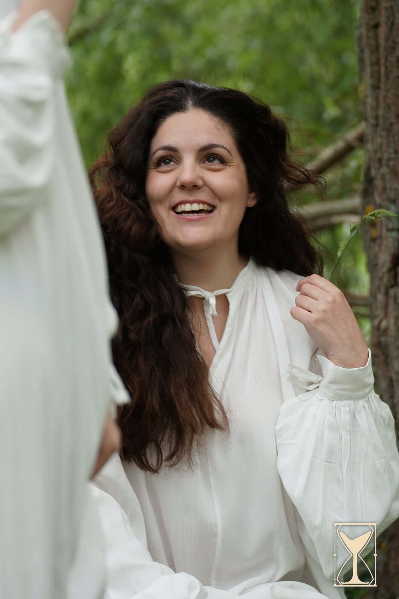 Smock Violet worn by a woman with long hair, smiling outdoors in a medieval-style chemise, showcasing elegance and comfort.