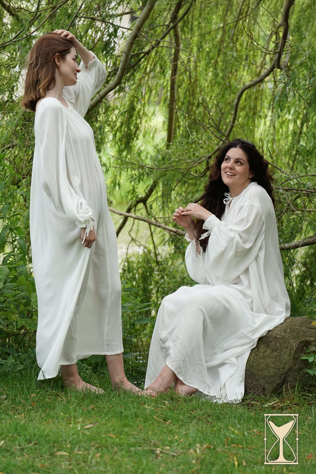 Two models in white Smock Violet undergarments, showcasing comfort and elegance in a natural setting.