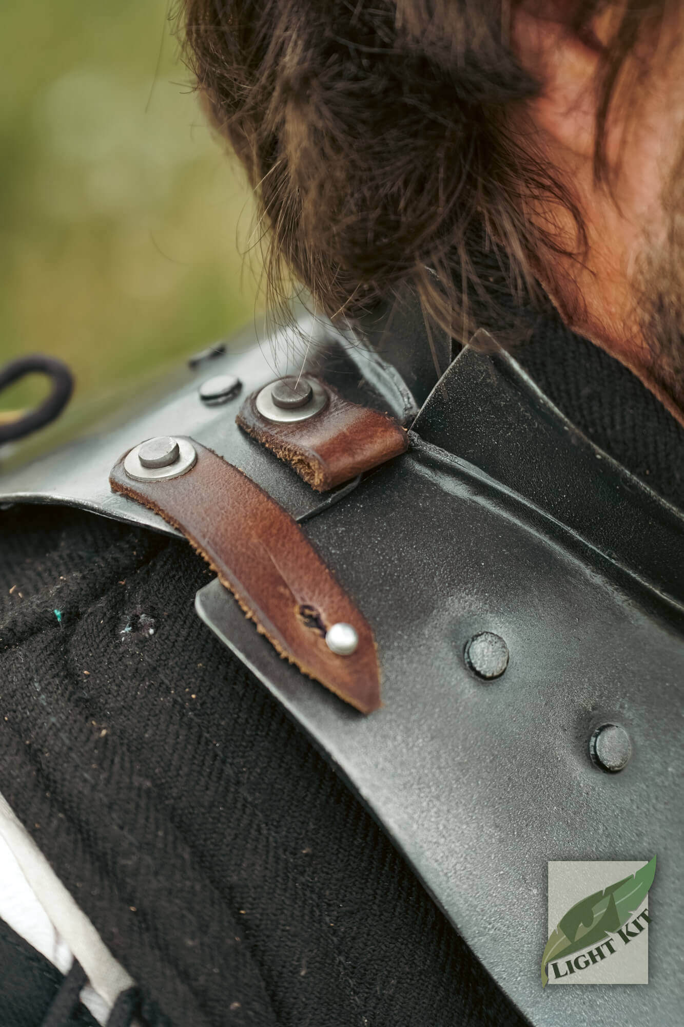 Detail of the Captain Gorget - Light Kit showcasing leather straps and metal fasteners on the shoulder.