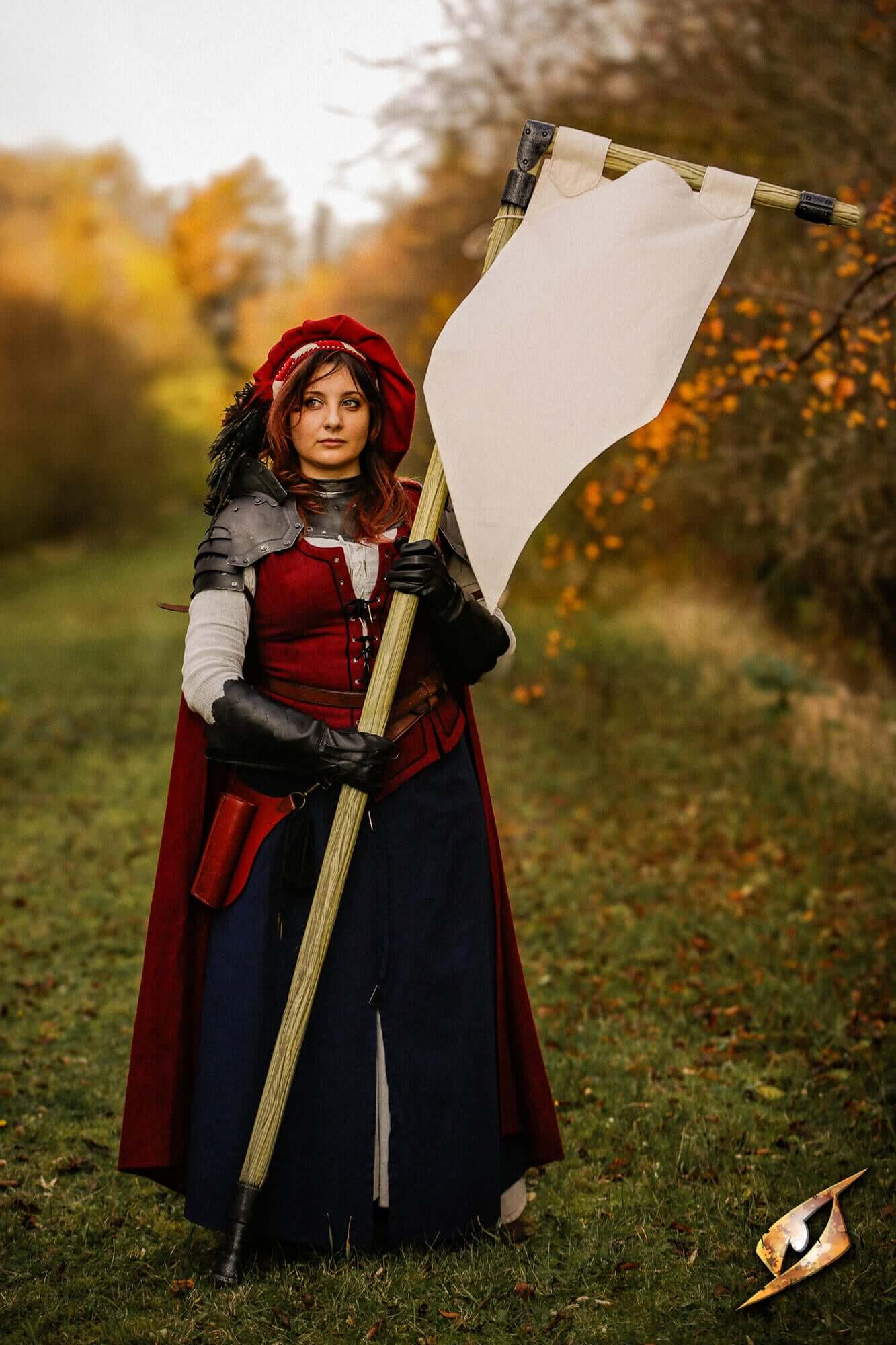 Battle Standard - Pennon: a woman in medieval costume holding a white flag in a natural setting with autumn colors.