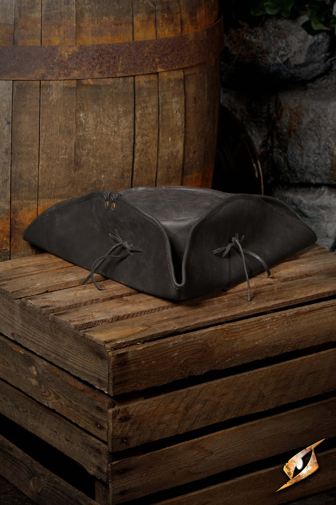 Simple Leather Pirate Tricorn Hat displayed on a wooden crate, perfect for completing a pirate costume.