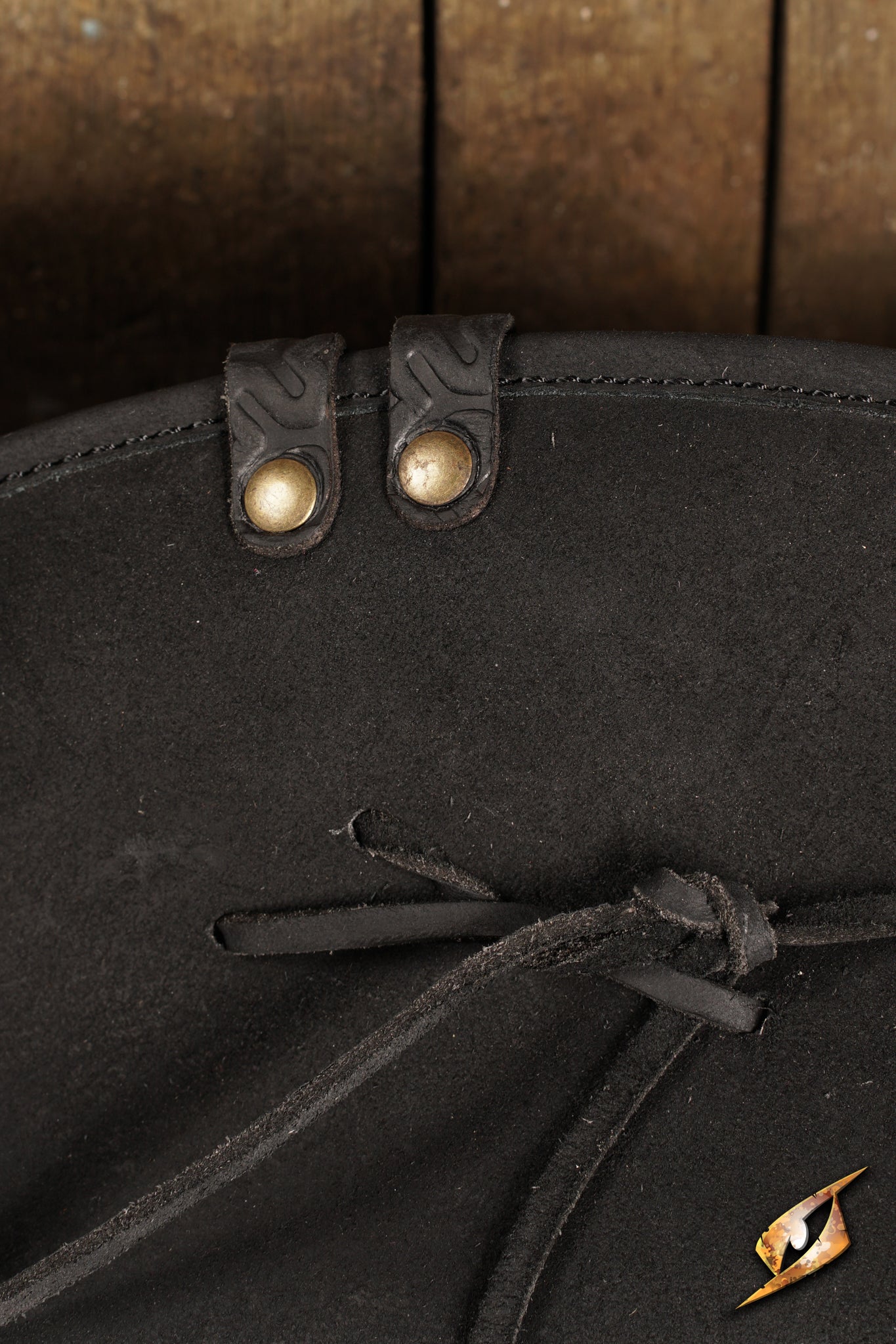 Simple Leather Pirate Tricorn Hat featuring detailed leather stitching and buttons on a rustic wooden background.