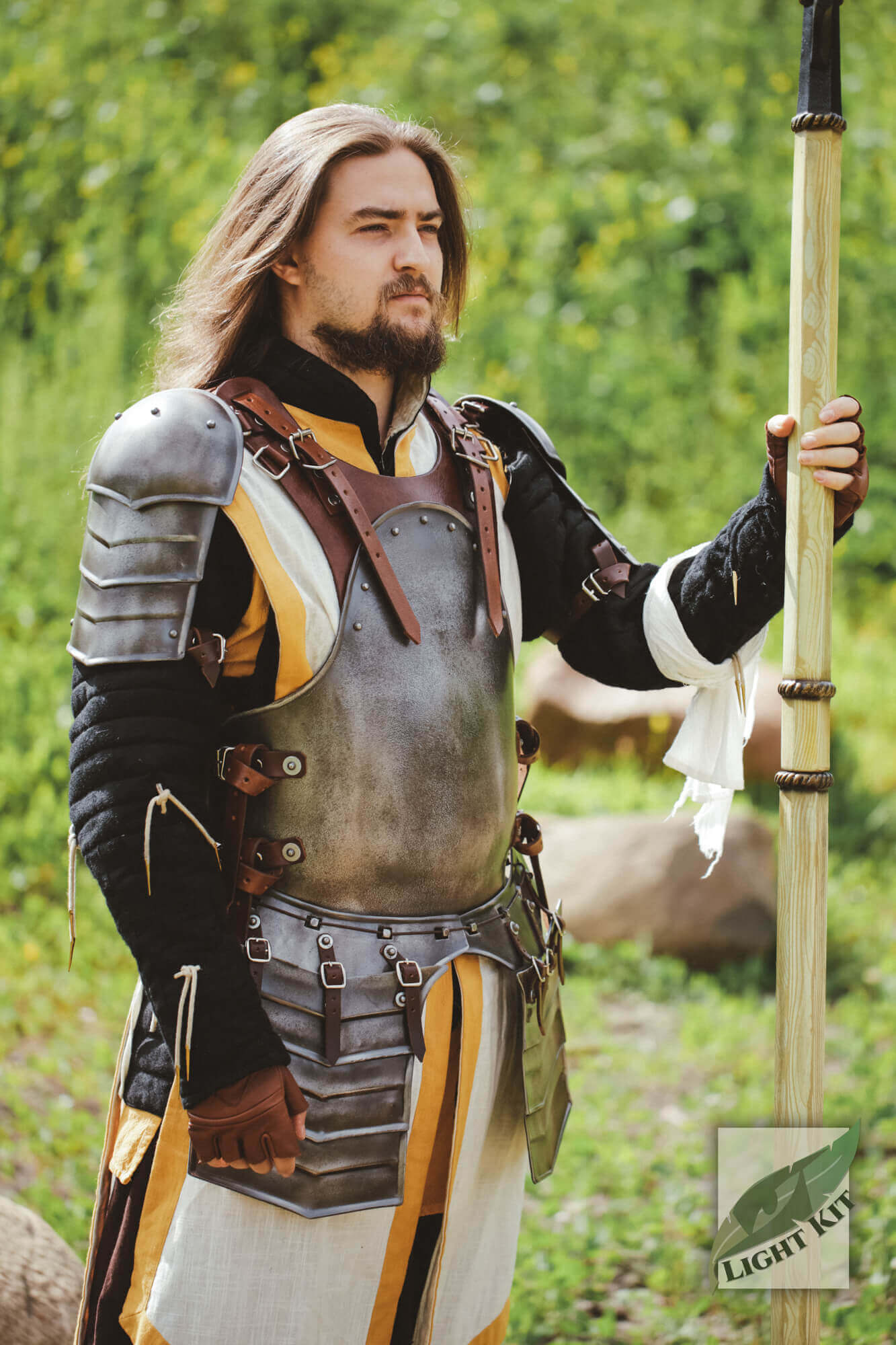 Torso Armour Merc - Light Kit worn by a man in armor with a spear in an outdoor setting.