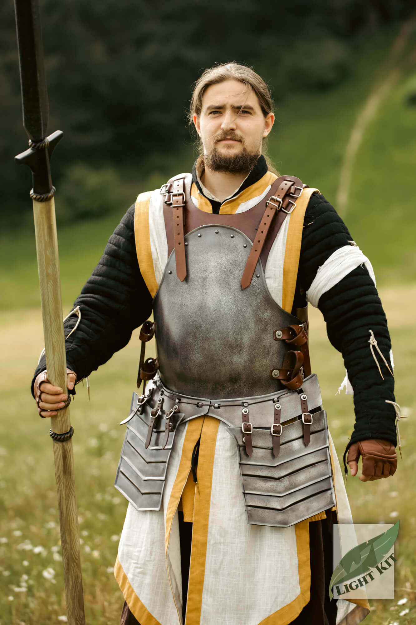 Merc Tassets - Light Kit worn by a model in Renaissance-style armor, featuring overlapping plates and a spear.
