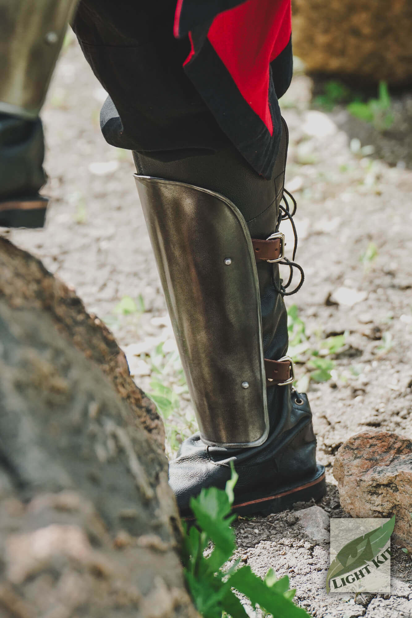 Close-up of RFB Leg Protection - Light Kit showing protective greave on a character's leg outdoors.