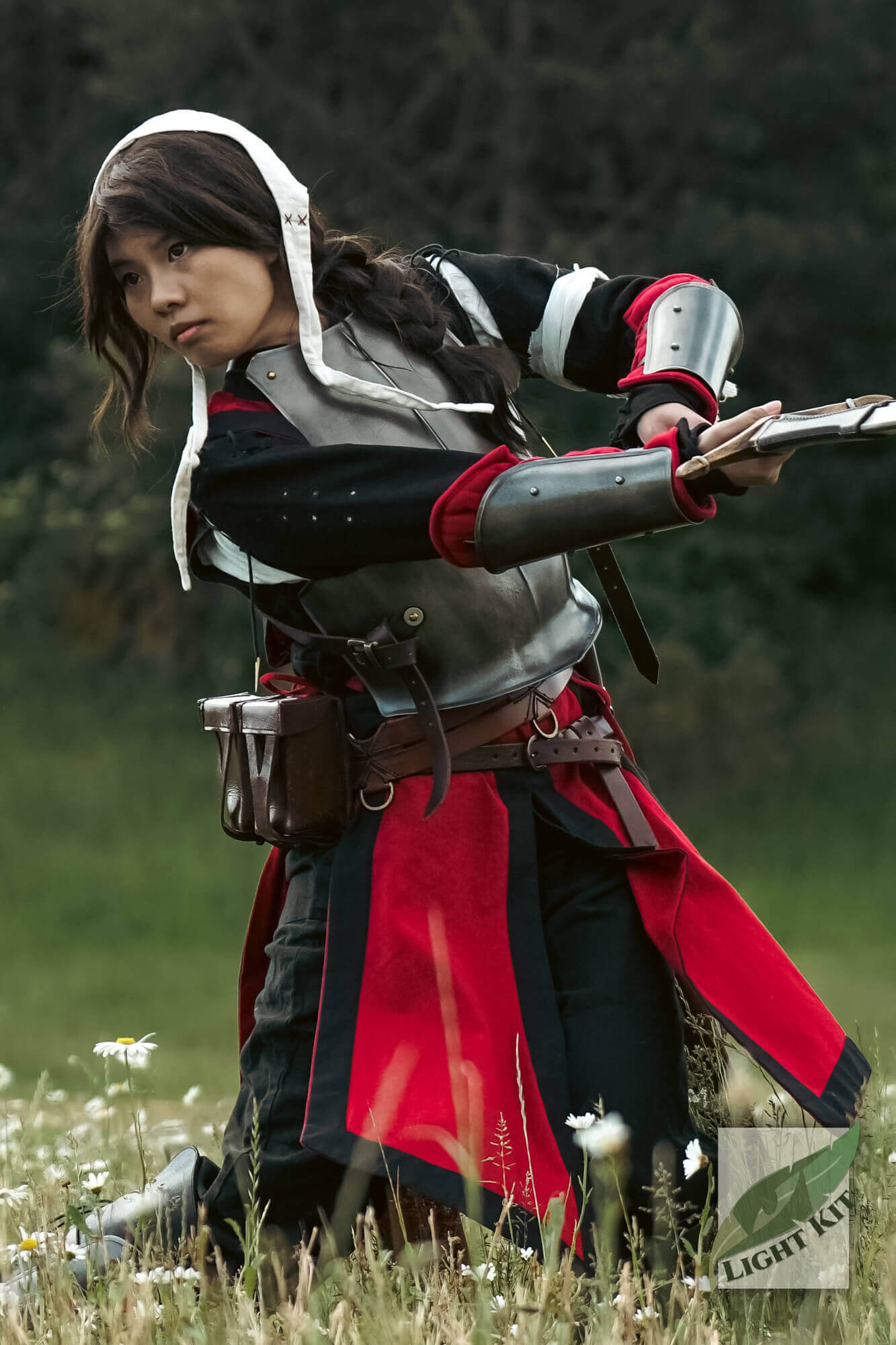 RFB Arm Protection - Light Kit worn by a character in a dynamic pose, showcasing versatile forearm guards in a lush outdoor setting.