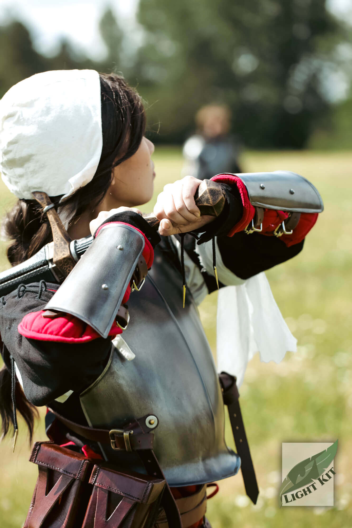 RFB Arm Protection - Light Kit worn by a character preparing for battle in a field.