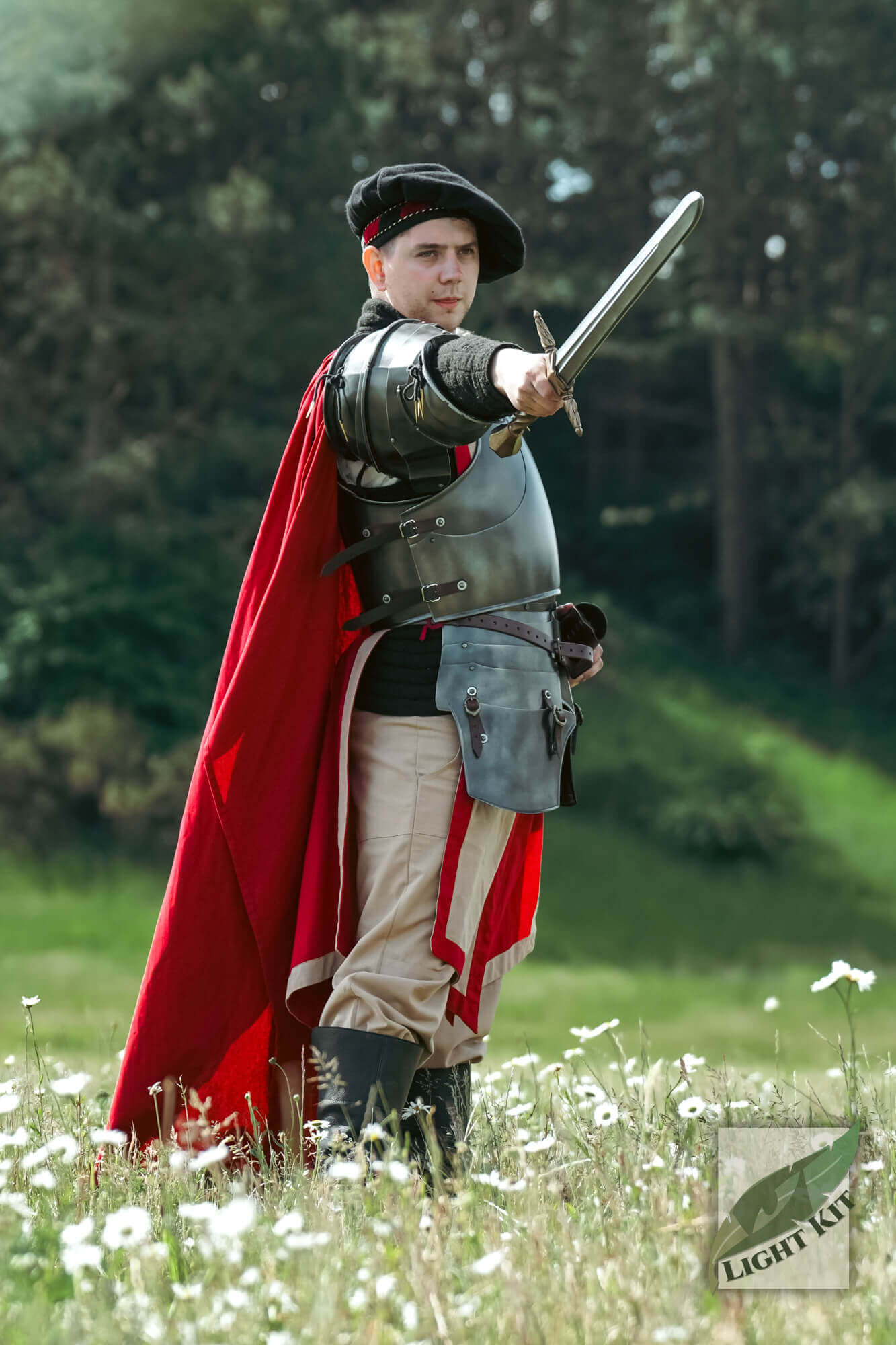 Man in Milanese Armour - Light Kit, wielding a sword, surrounded by flowers in a natural setting.