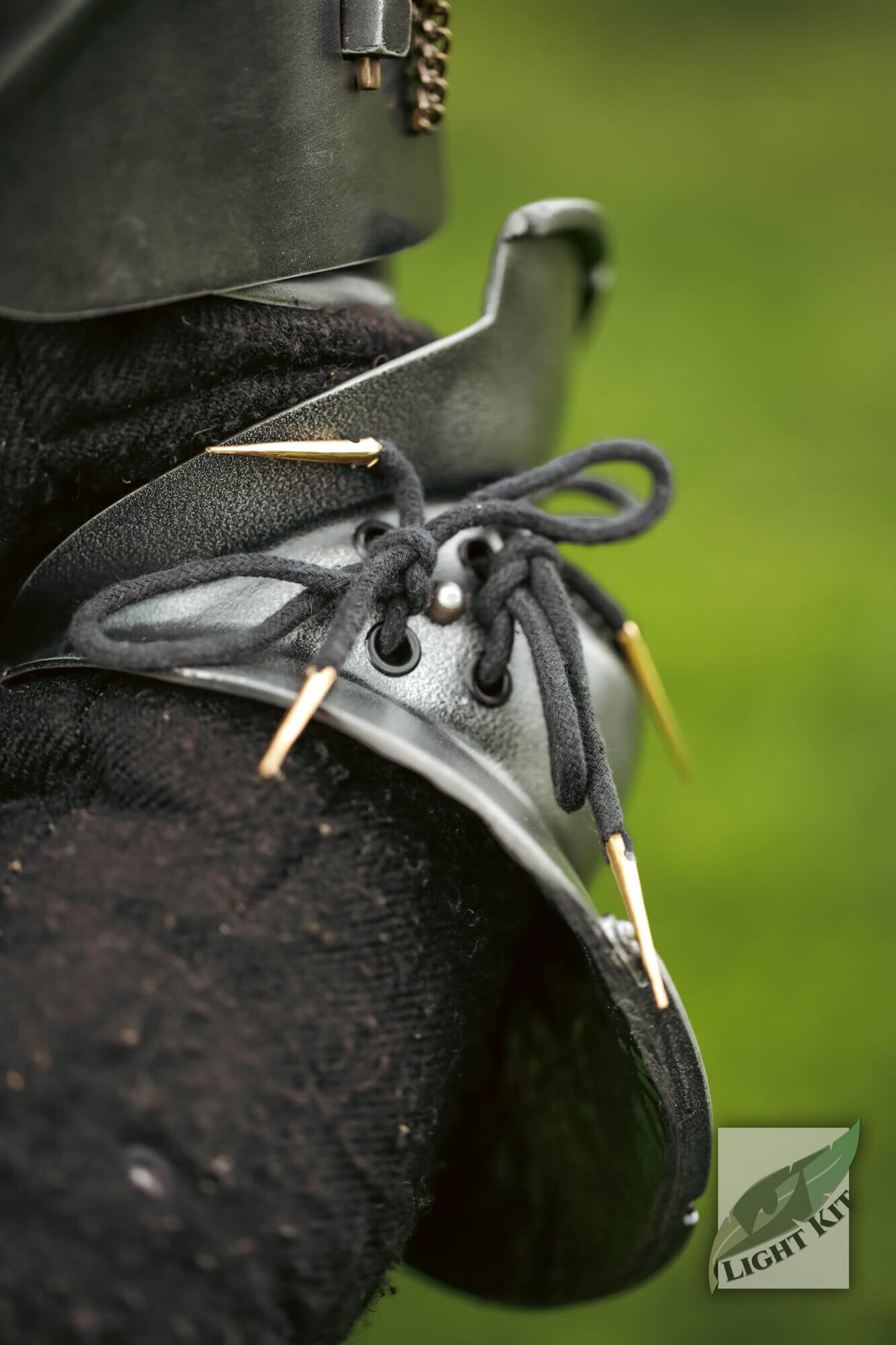 Milanese Couters - Light Kit showcasing the innovative design with laces and protective spikes for elbow defense.