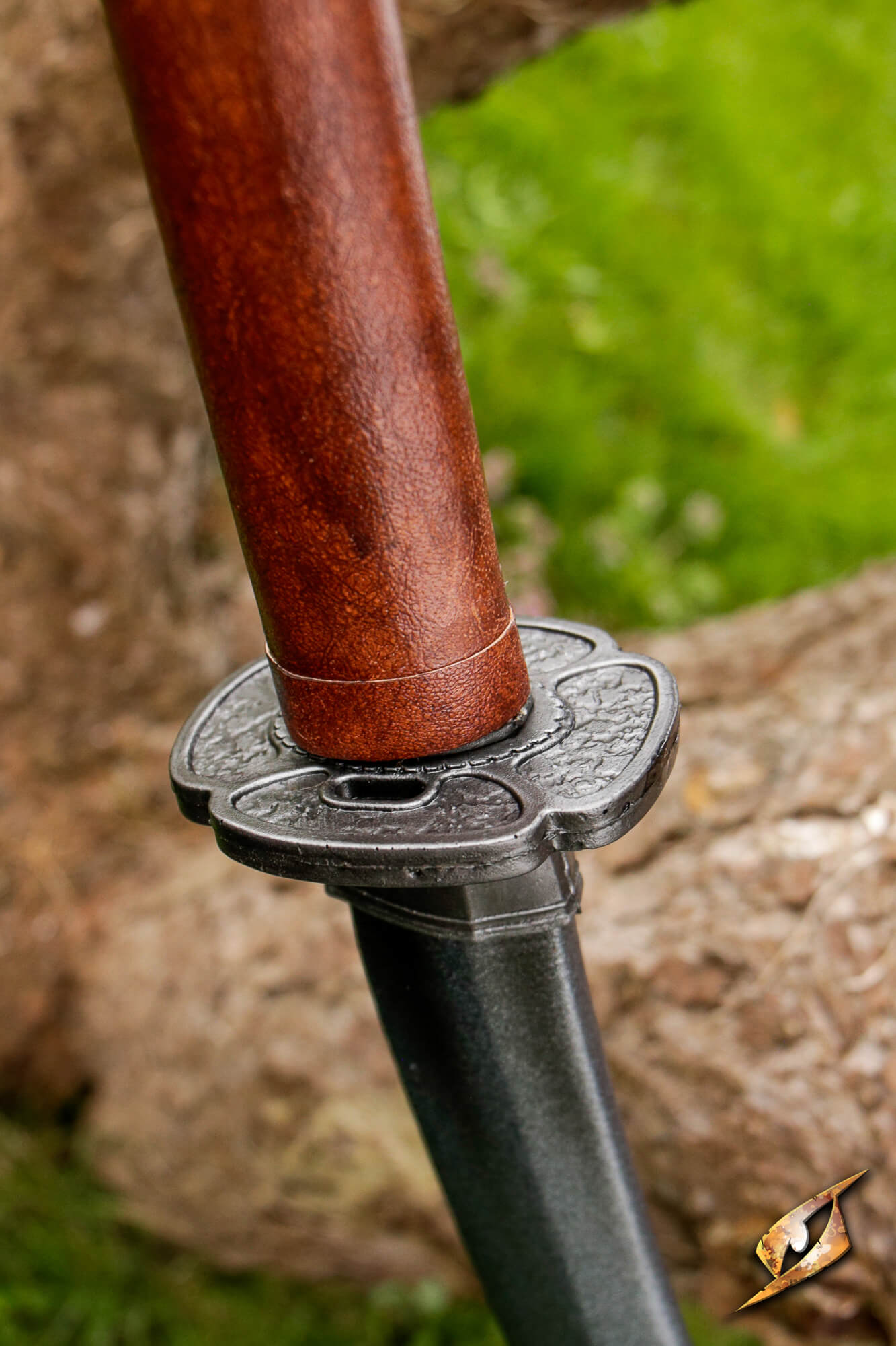 Mokko-gata Tsuba shown on sword hilt, featuring classic four-lobed design and durable polyurethane material.