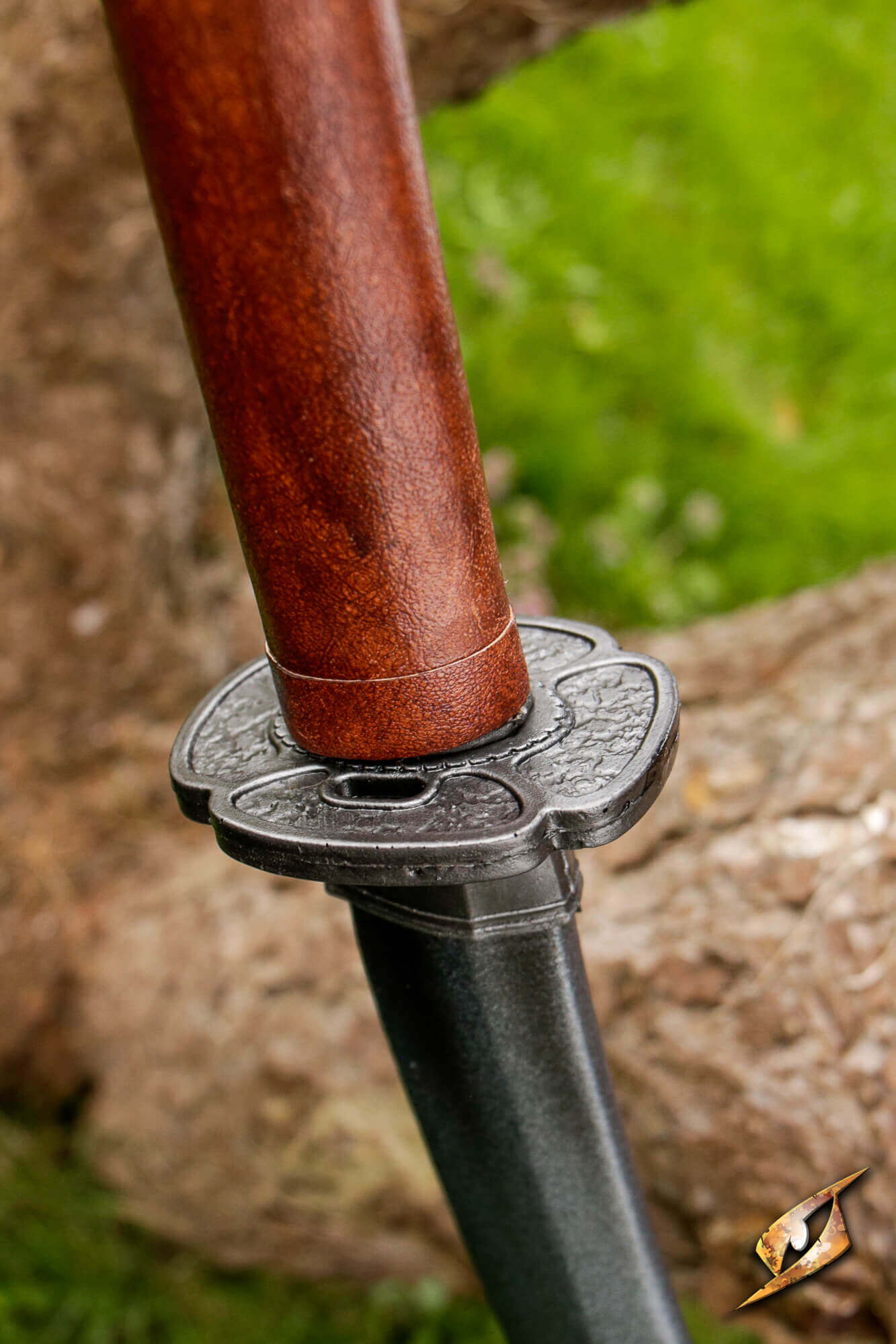 Mokko-gata Tsuba shown on sword hilt, featuring classic four-lobed design and durable polyurethane material.