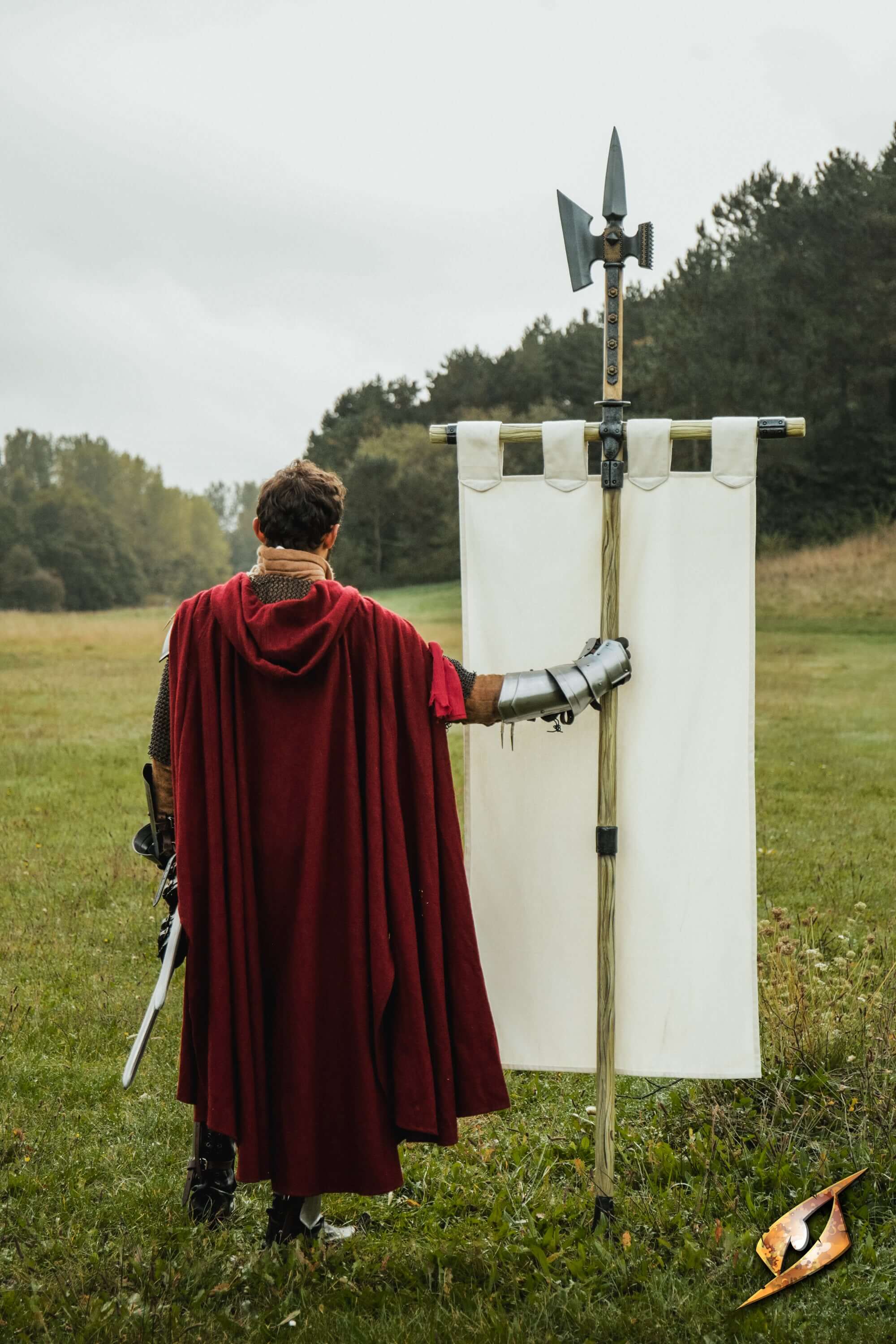 Complete Battle Standard Set - Halberd Top held by a figure in a red cape outdoors, showcasing its sharp design.