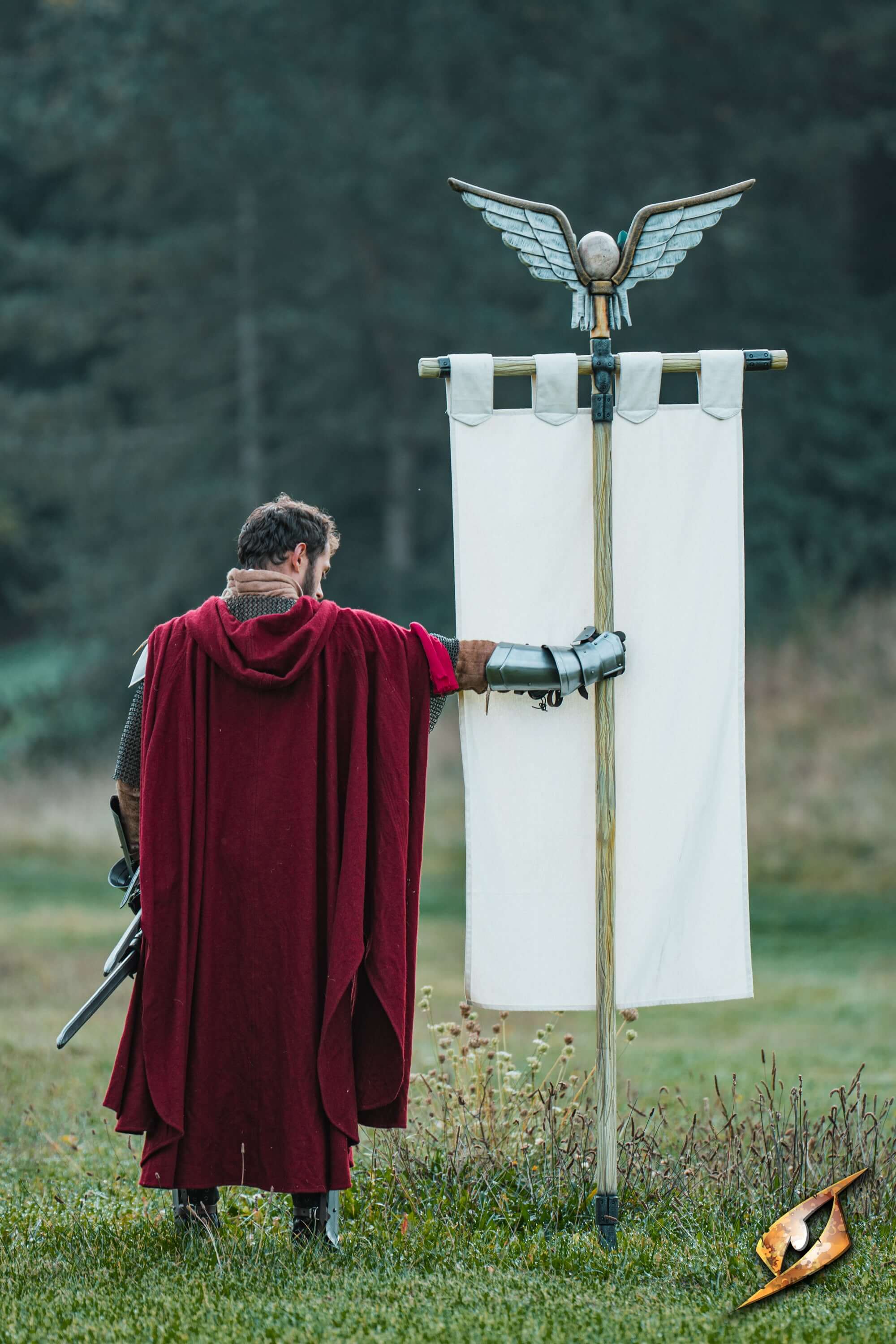 Complete Battle Standard Set - Winged Skull Top showcased outdoors with a warrior in a red cloak.
