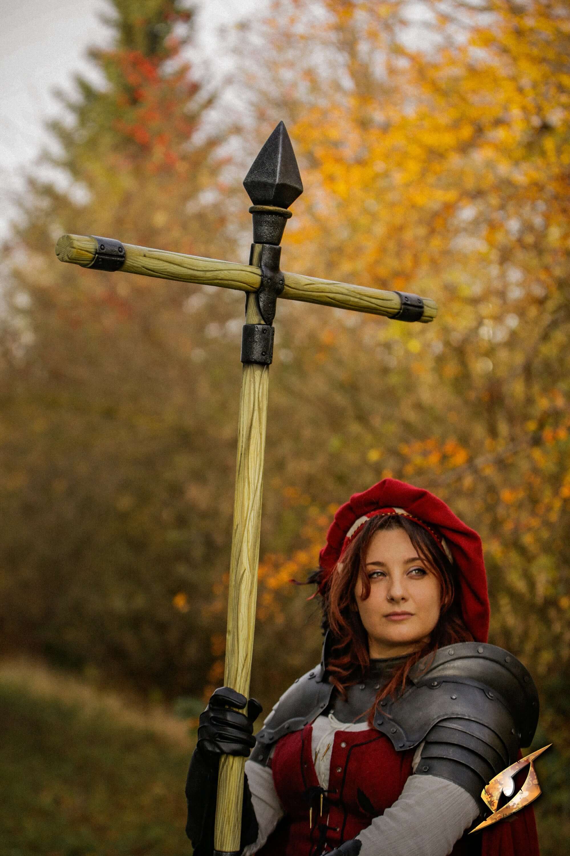 Complete Battle Standard Set - Spear Top held by a woman in armor with a red hood in a forest setting.
