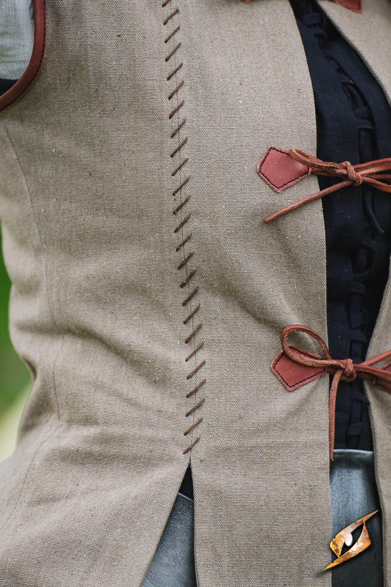 Rugged Canvas Jerkin featuring decorative hand stitching and leather cord ties on the front.
