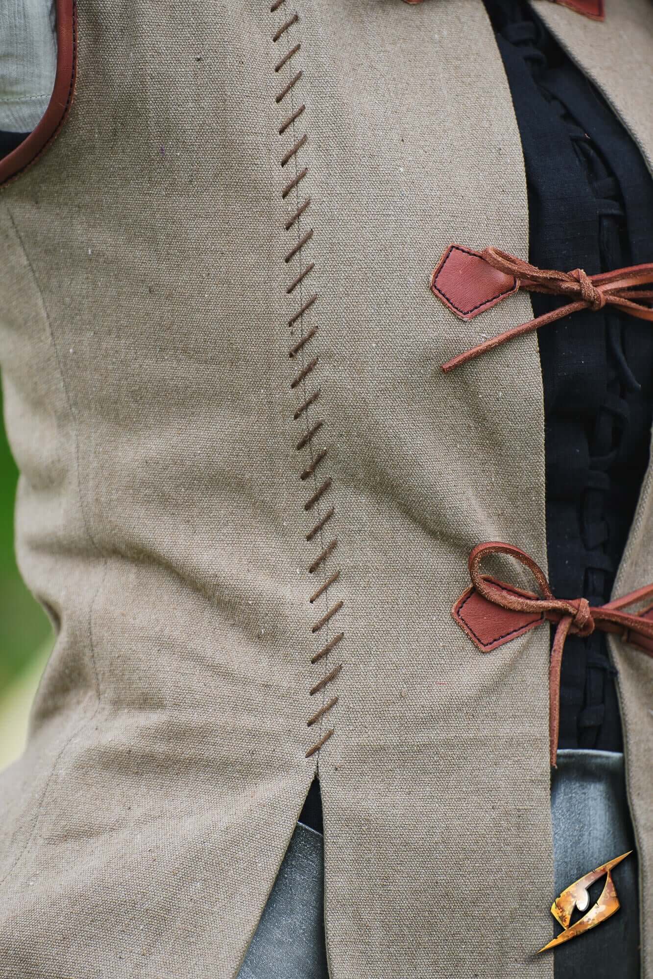 Rugged Canvas Jerkin featuring decorative hand stitching and leather cord ties on the front.
