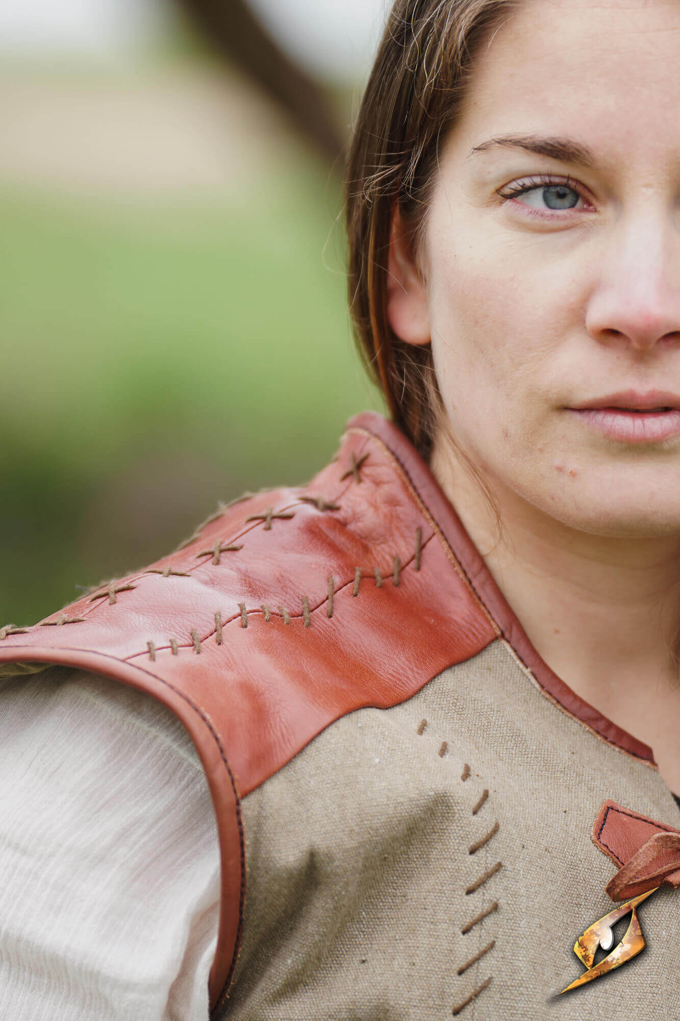 Rugged Canvas Jerkin featuring leather shoulder reinforcement and decorative hand stitching details.