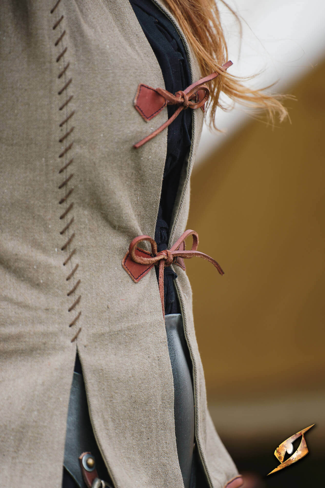 Detail of the Rugged Canvas Jerkin showing leather cord ties and decorative hand stitching.