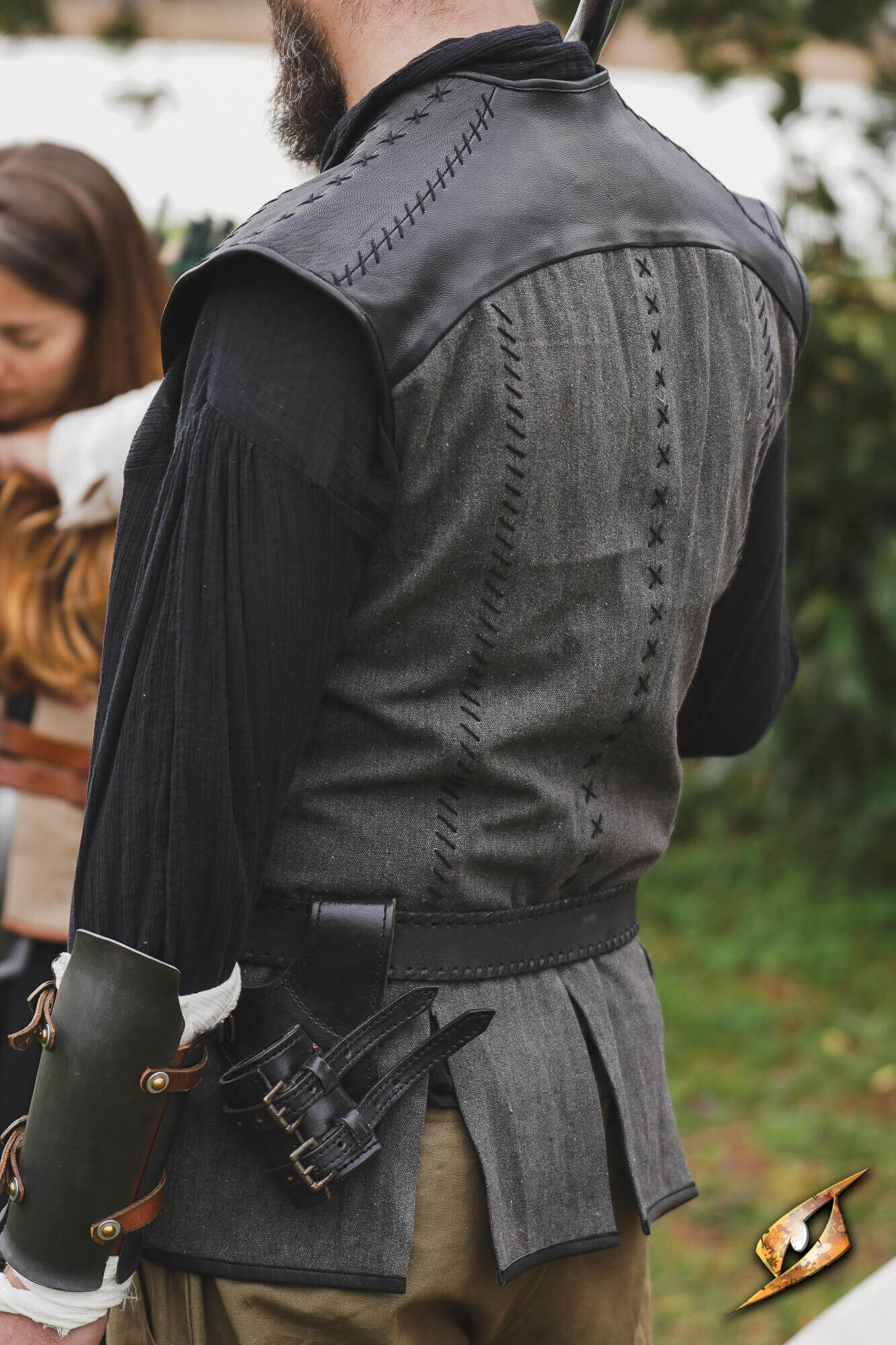 Rugged Canvas Jerkin featuring leather shoulder reinforcement and decorative stitching on the back.