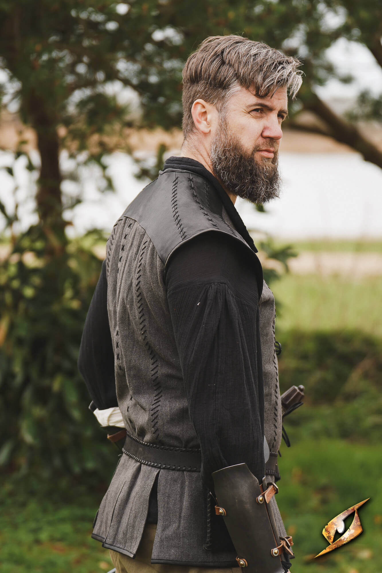 Man wearing a Rugged Canvas Jerkin, showcasing the stylish design and sturdy shoulder reinforcement.