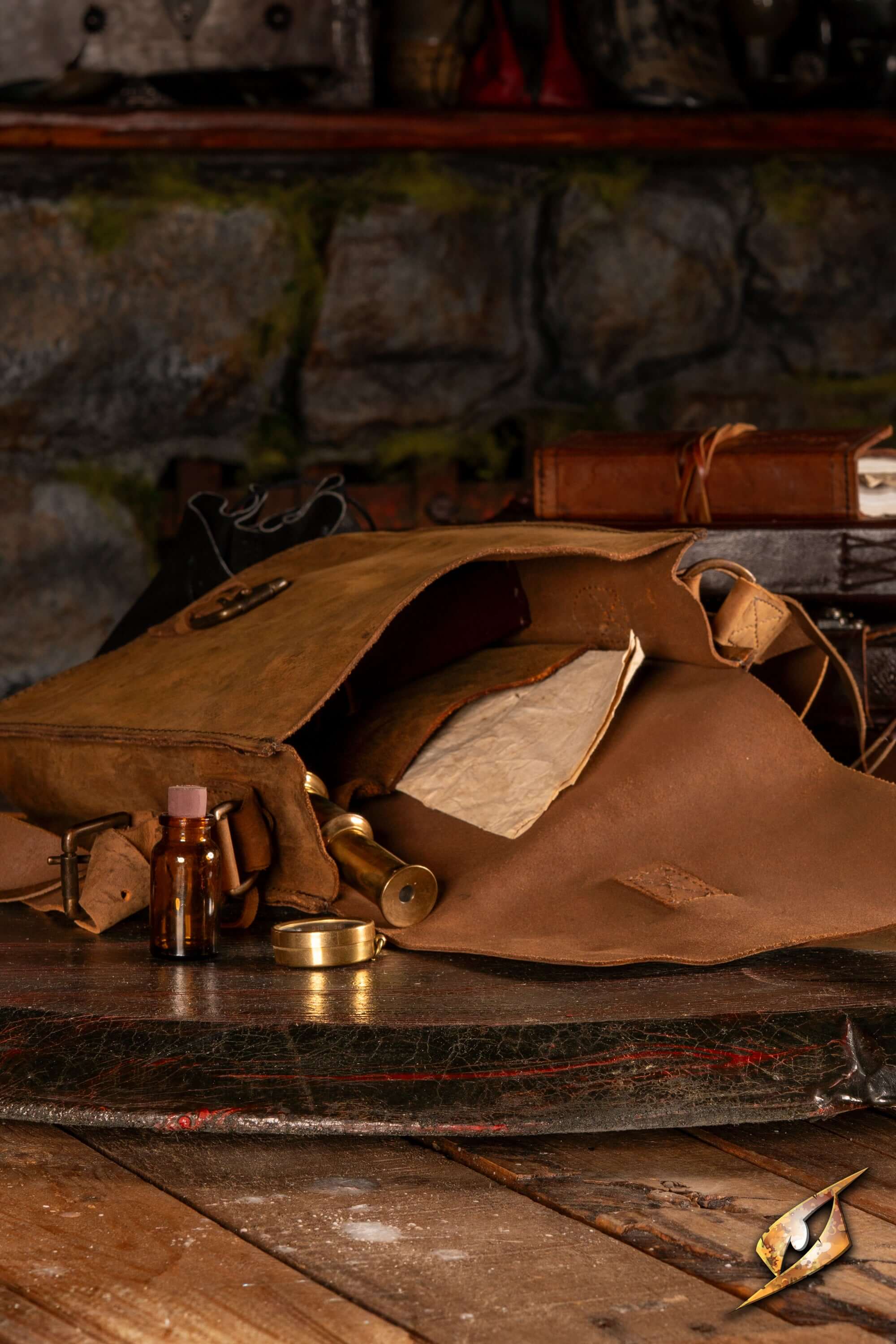 Traveler's Satchel – Pull-Up Leather with open design, book, and accessories on rustic wooden table.