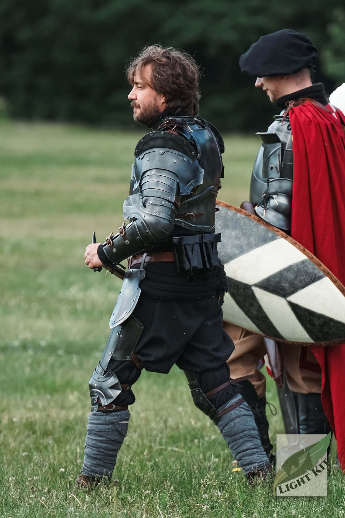 Captain Complete Set - Light Kit worn by a knight in a grassy field, showcasing epic matte black armor design.