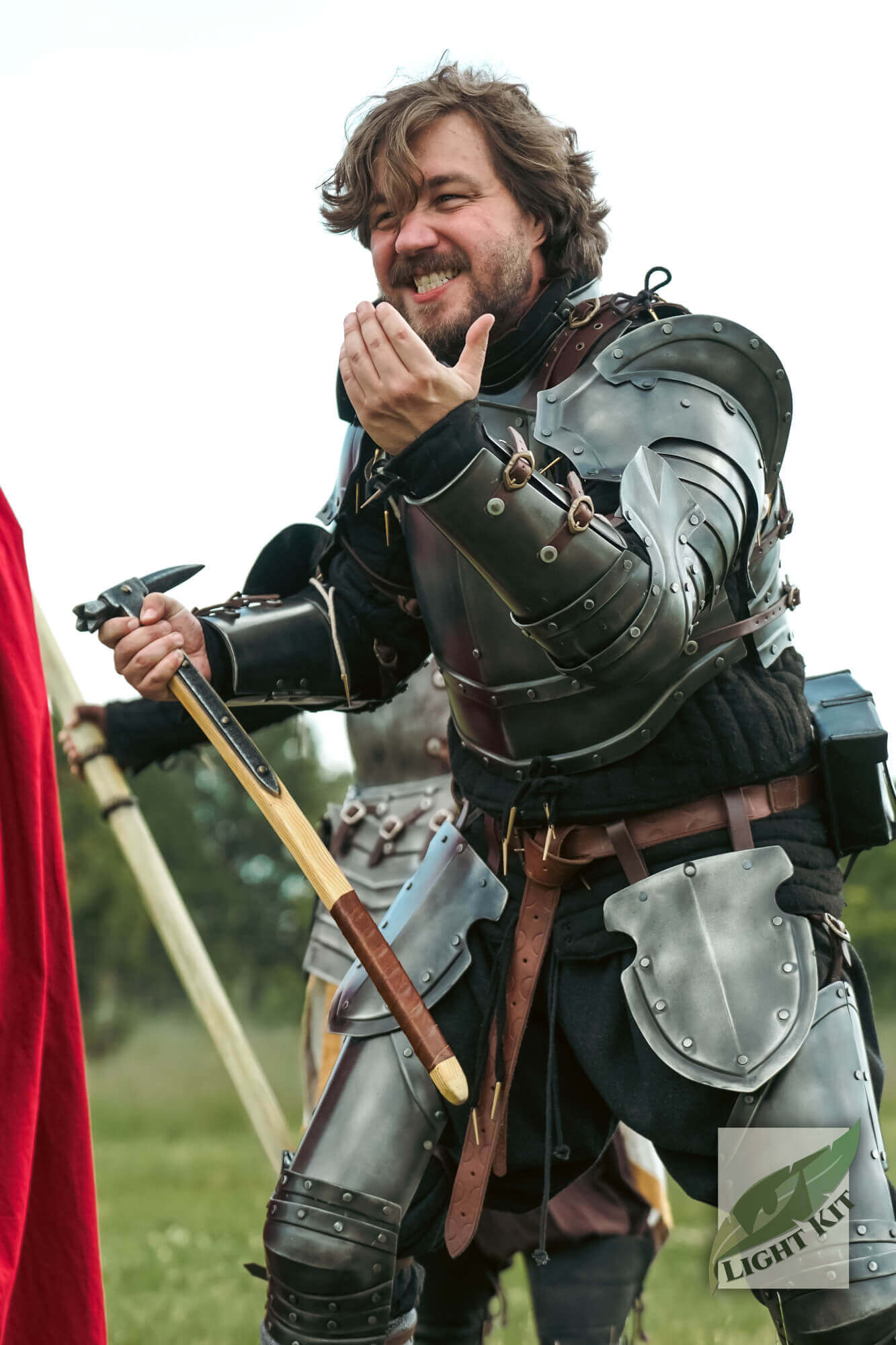 Captain Complete Set - Light Kit worn by a smiling man in armor, showing commanding pose on the field.