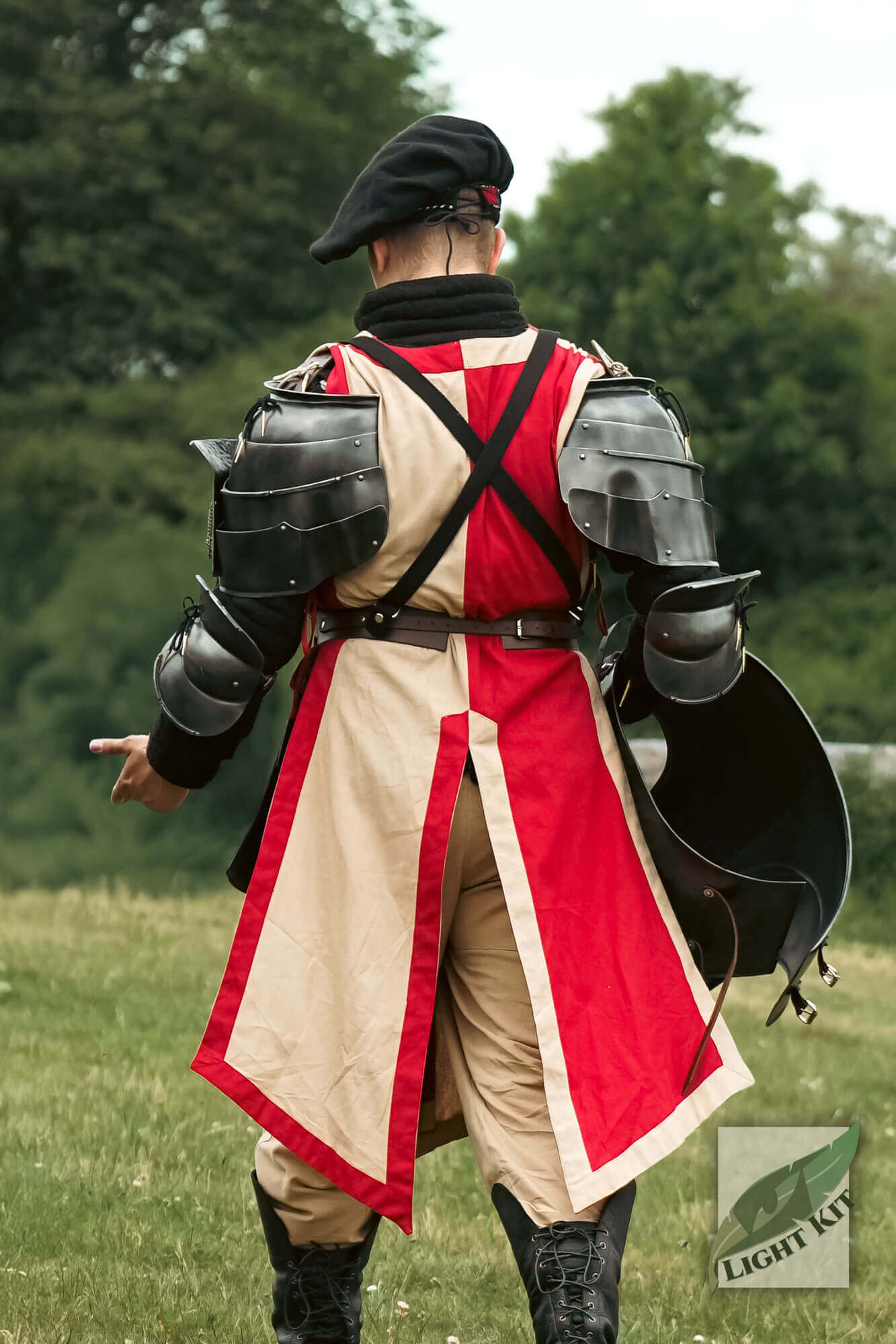 Milanese Complete Set - Light Kit showing a knight in armor from the back on a grassy field.